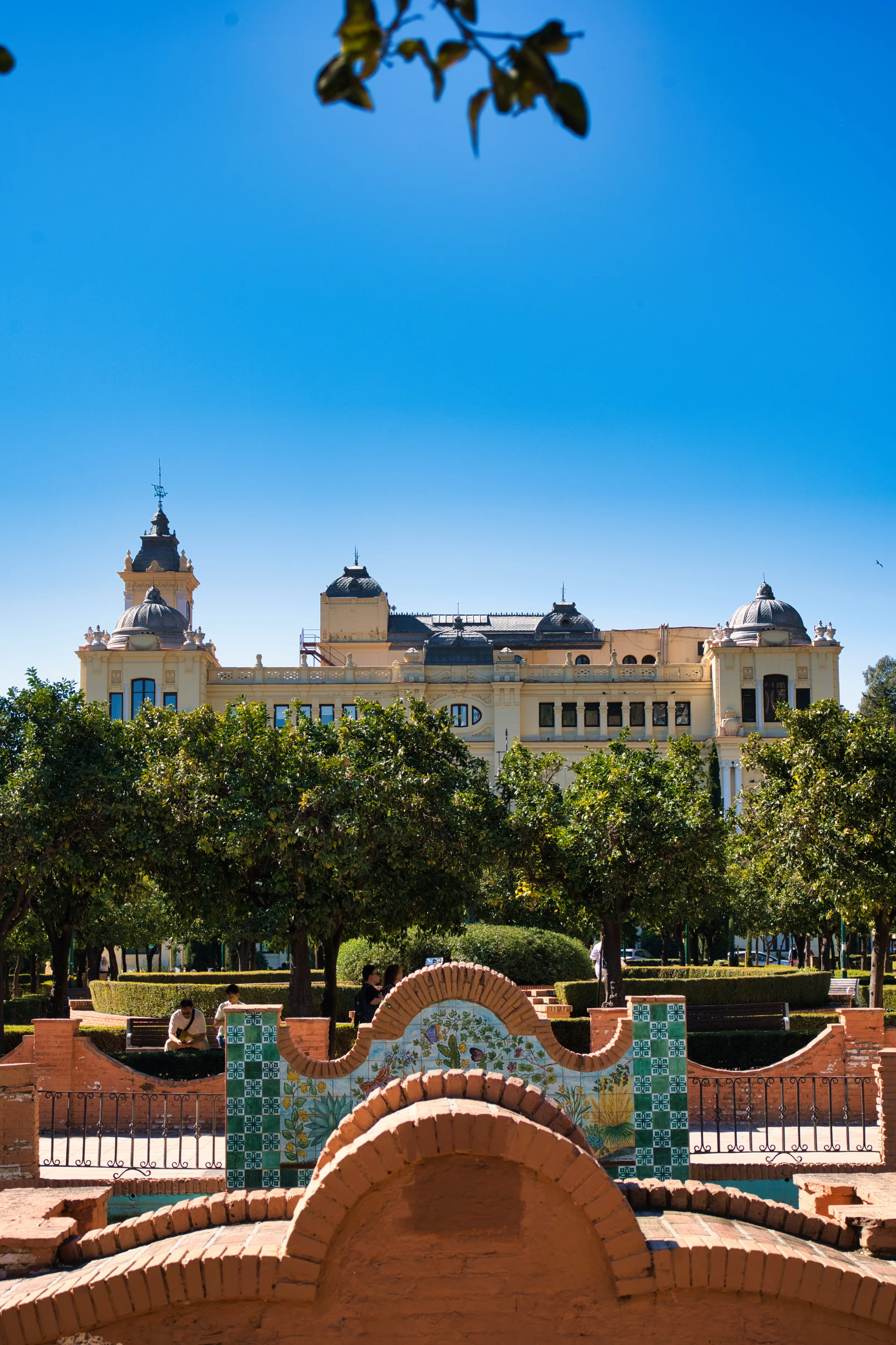 View through the gardens toward Malaga's historic city centre on a clear September day