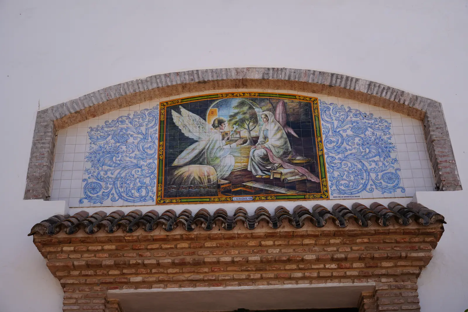 Hand-painted ceramic Annunciation mural above a doorway at the Iglesia de la Encarnacion in Marbella