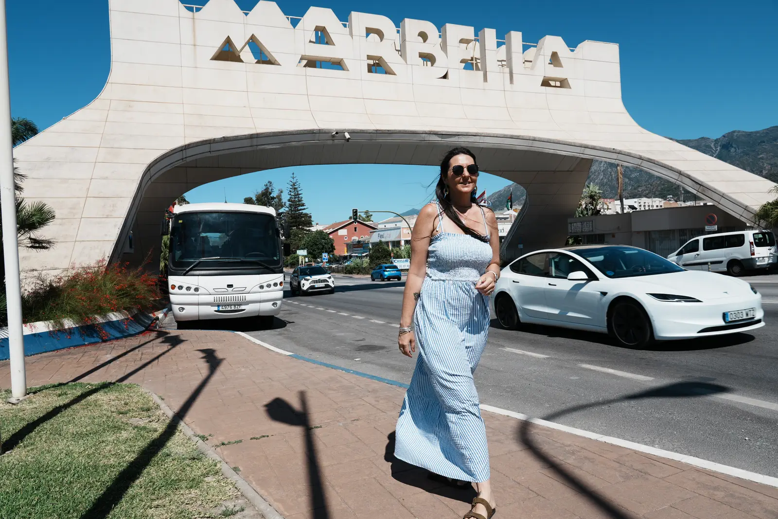 heidi walking under the marbell sign