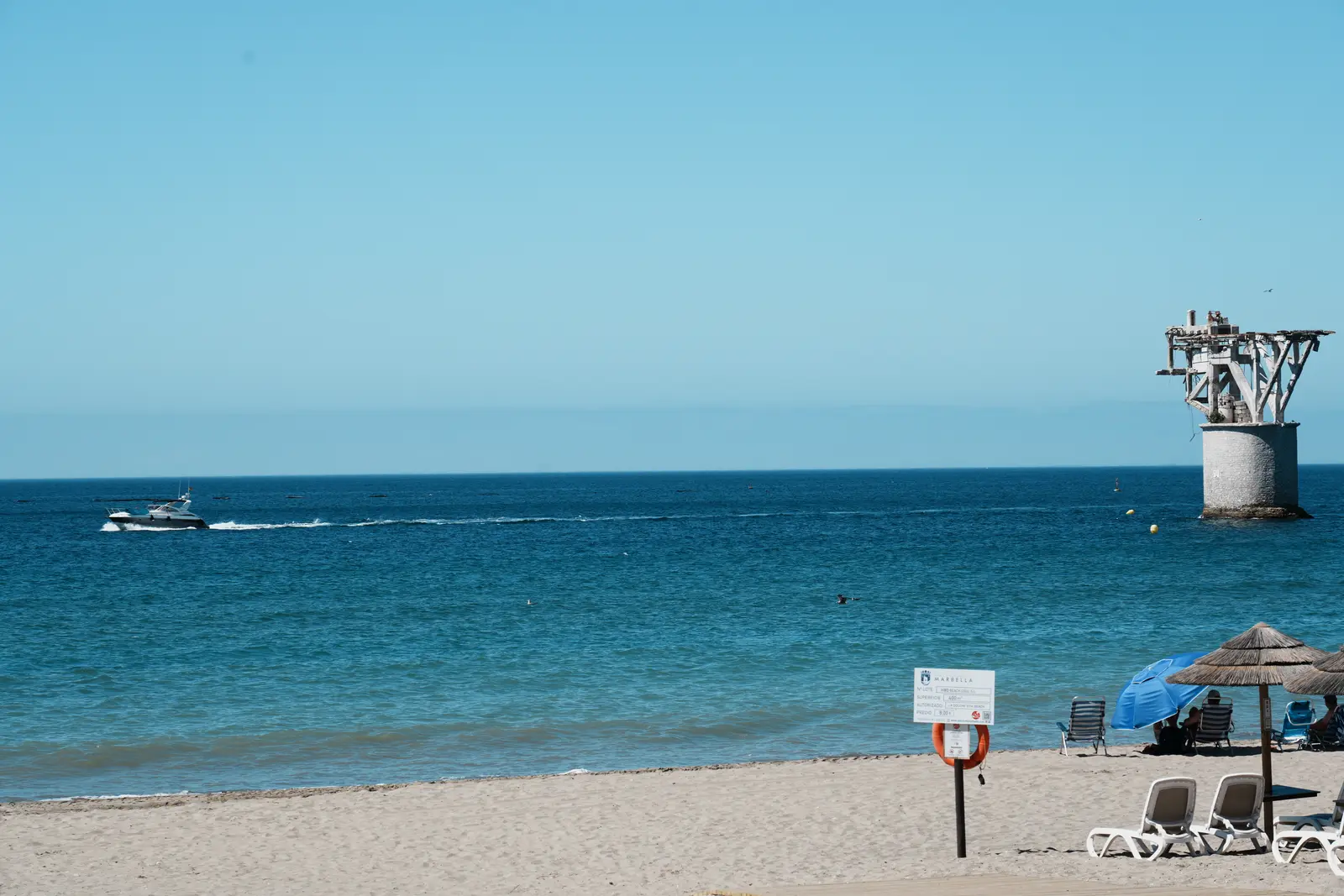 Cabopino tower and boat on the sea in Marbella