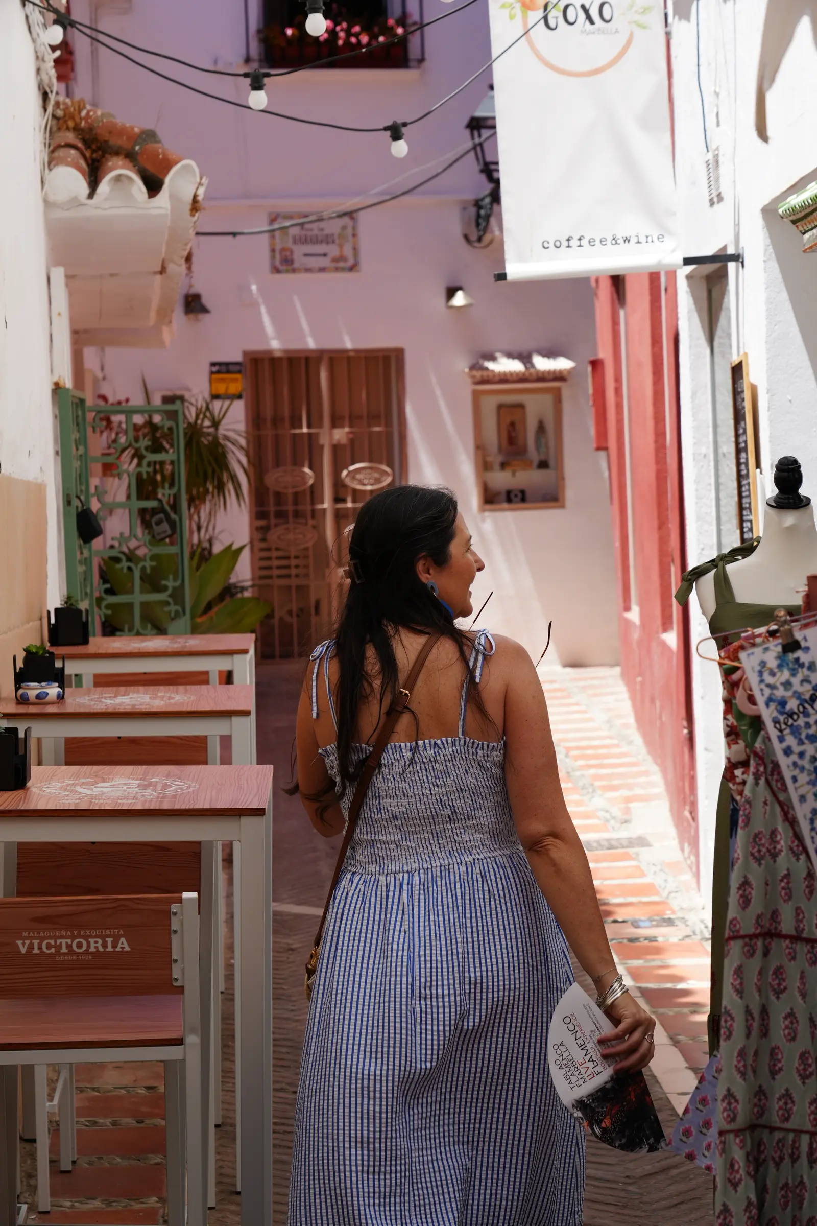 Heidi walking down a street in Marbella's Old Town.