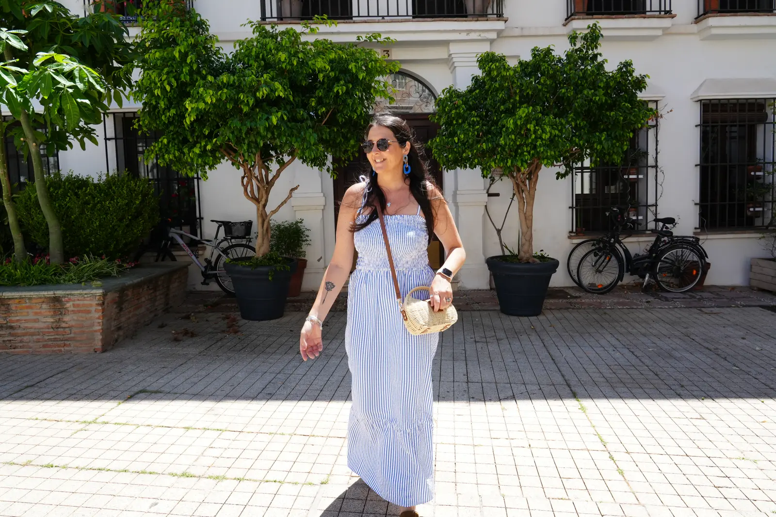 woman walking through streets in old town Marbella.