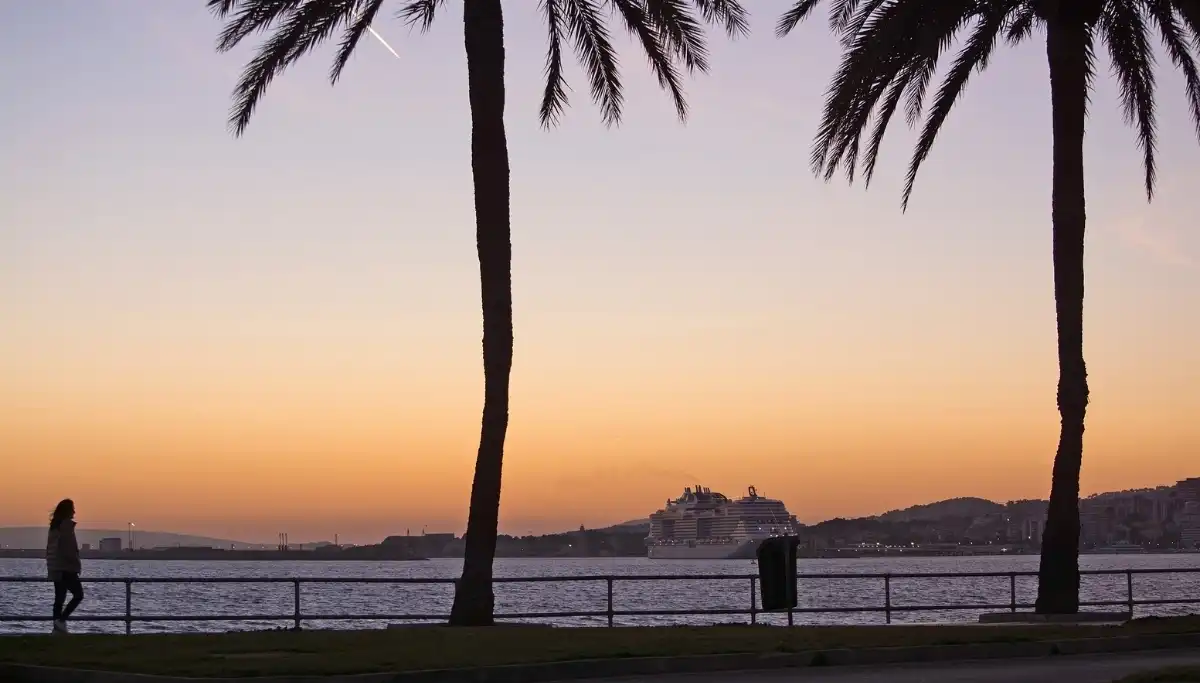 Walkers on the Paseo Maritimo seafront promenade in Marbella at sunset