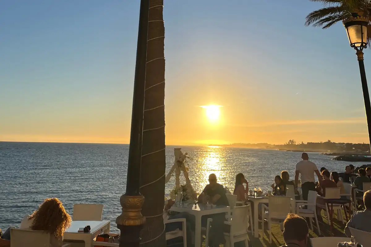 Sunset over the Marbella beachfront in Marbella, sitting at a cafe enjoying.a sundowner.