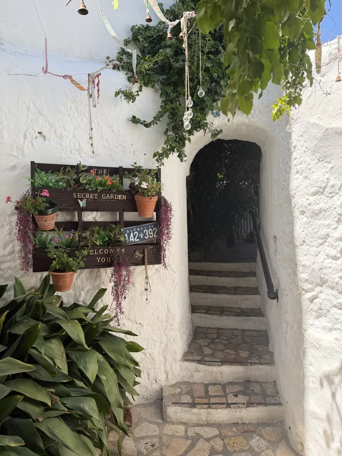Plant-covered entrance to The Secret Garden restaurant in Mijas Pueblo