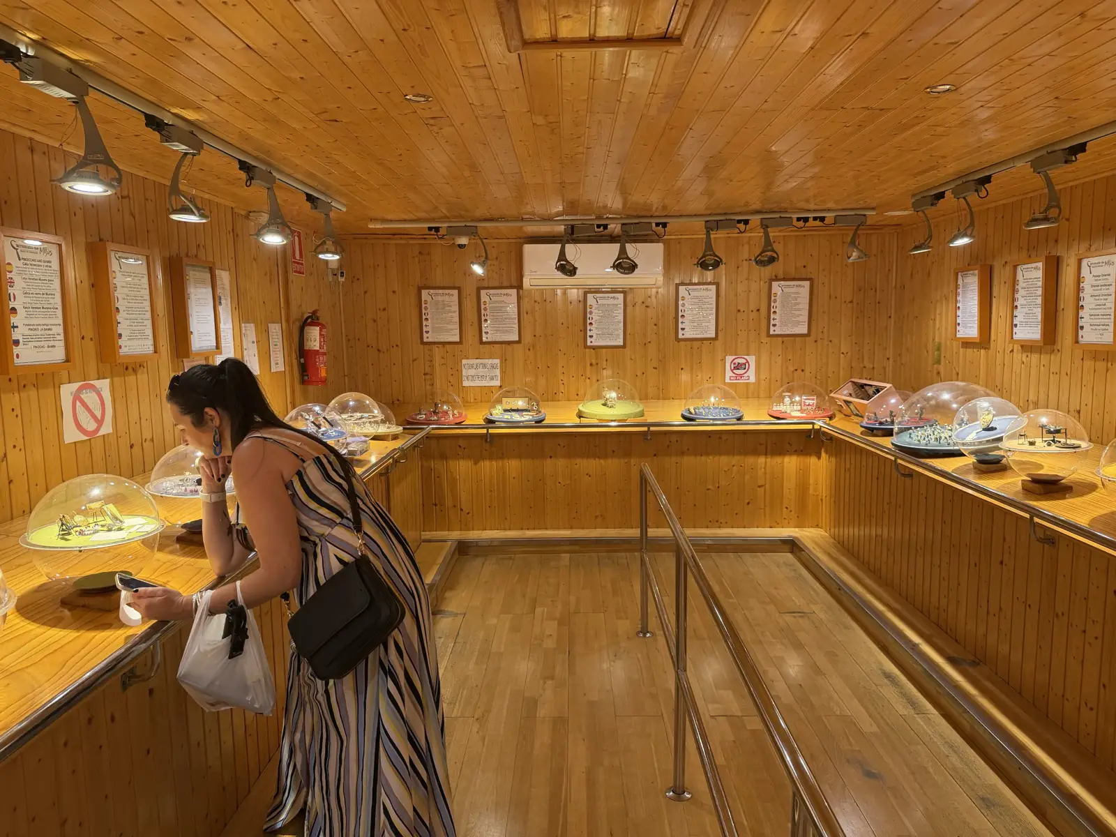 Wood-panelled interior of the Carromato wagon housing the Museum of Miniatures in Mijas Pueblo