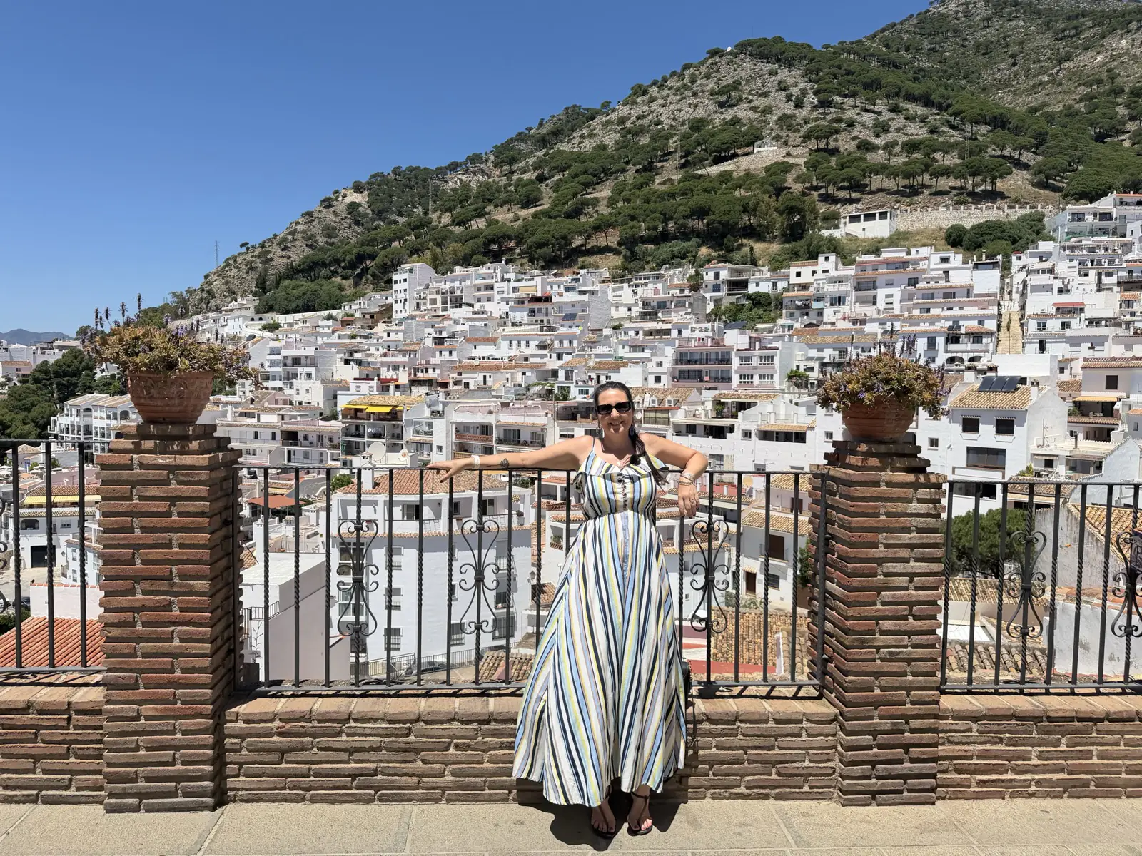 Heidi at a viewpoint overlooking the whitewashed hillside of Mijas Pueblo