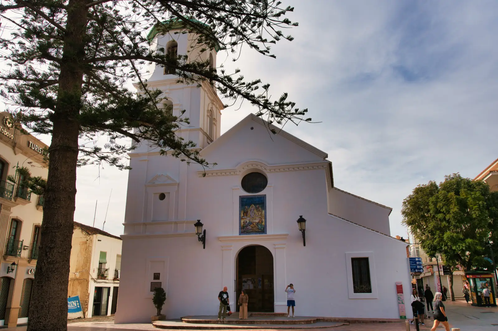 White baroque facade of El Salvador Church beside the Balcón de Europa, Nerja