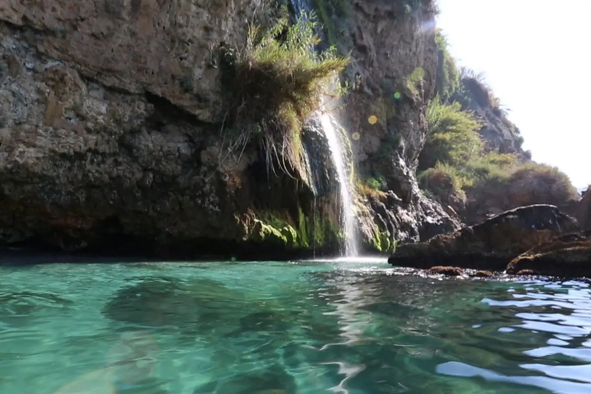 Maro Beach, a sheltered cove framed by dramatic cliffs in the Maro-Cerro Gordo Natural Park