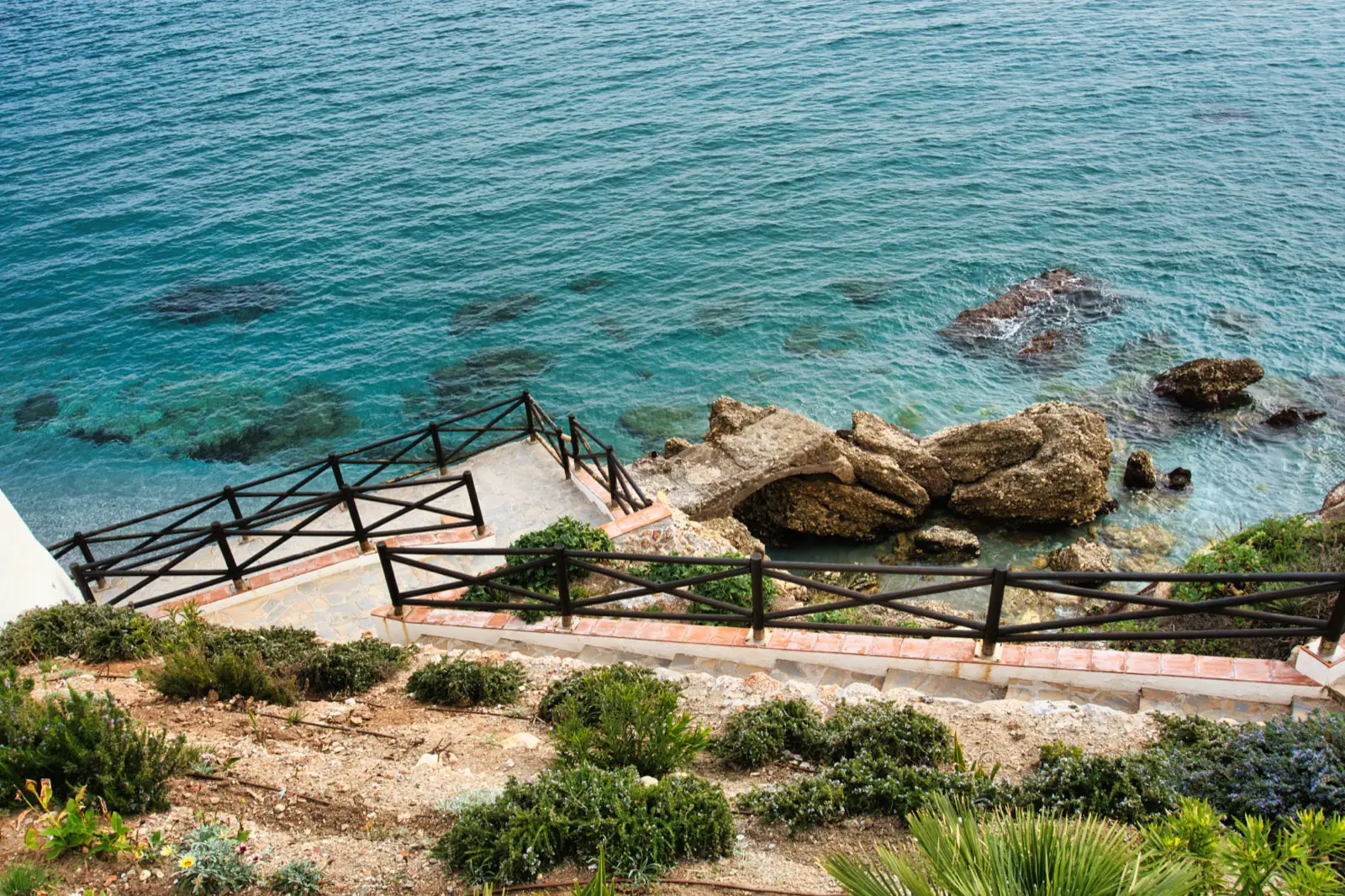Steps leading down to a beach in Nerja's compact old town