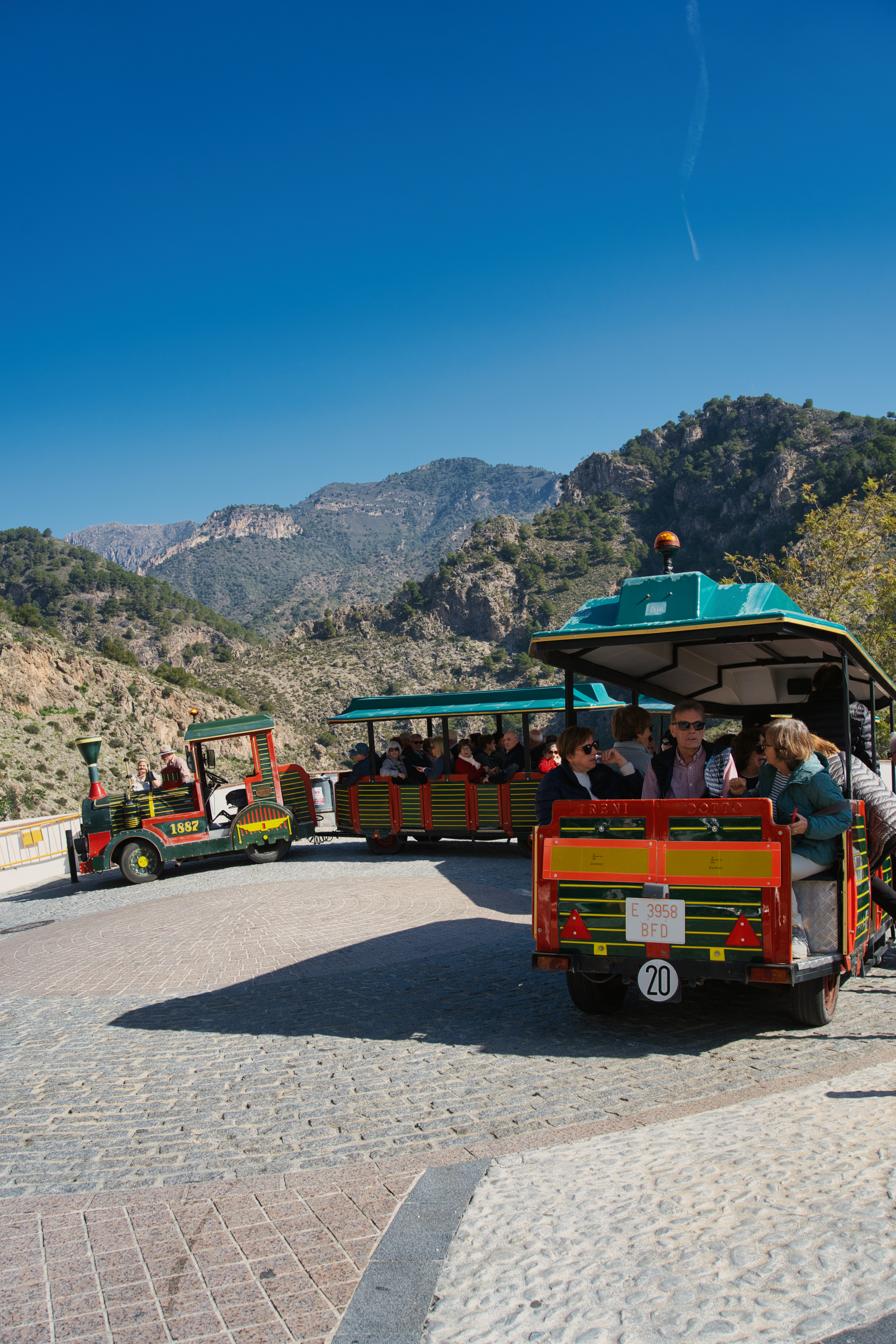 The Frigiliana tourist train winding along a mountain road