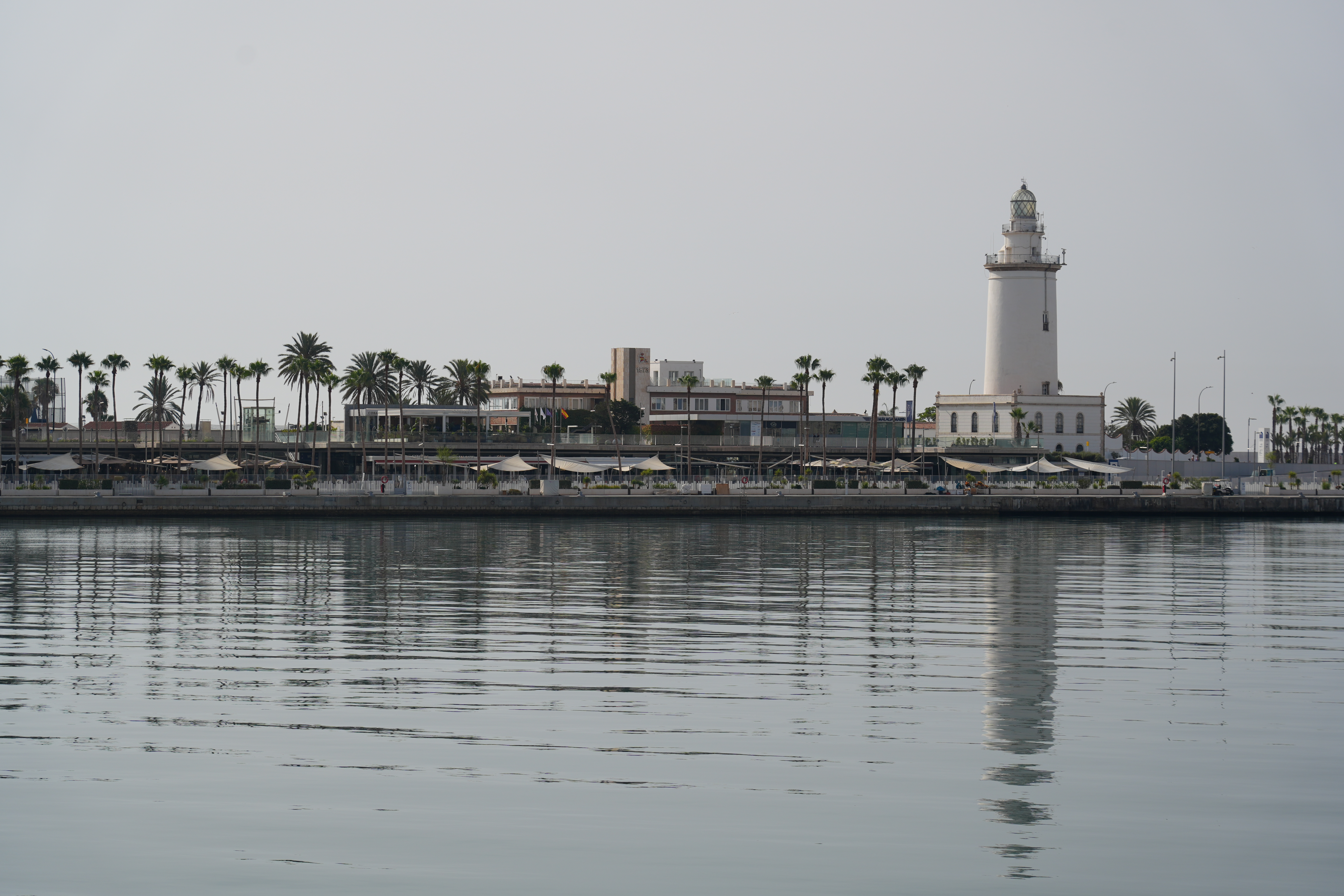La Farola lighthouse reflected in Malaga's harbour