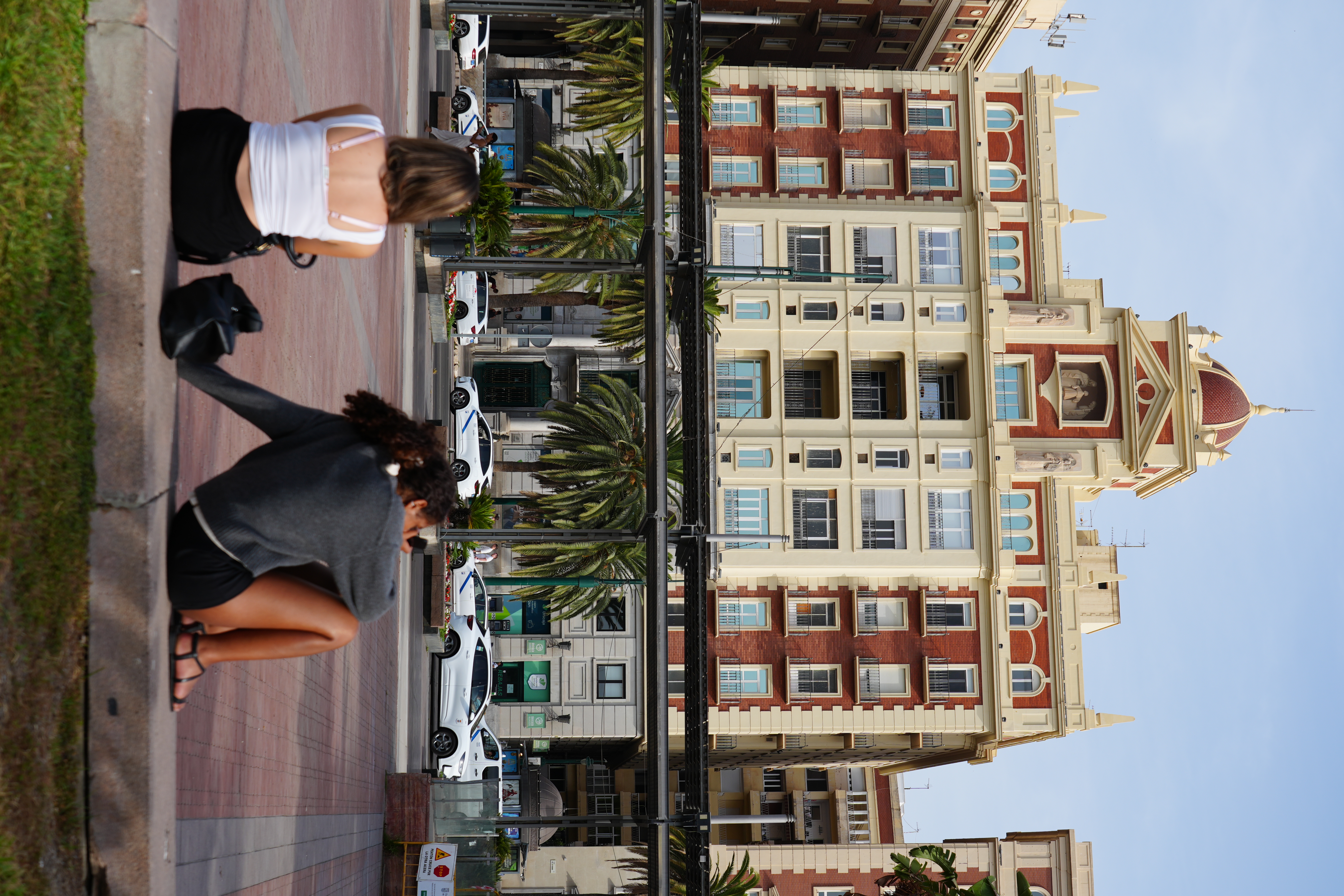 A plaza street in Malaga lined with ornate red-brick buildings