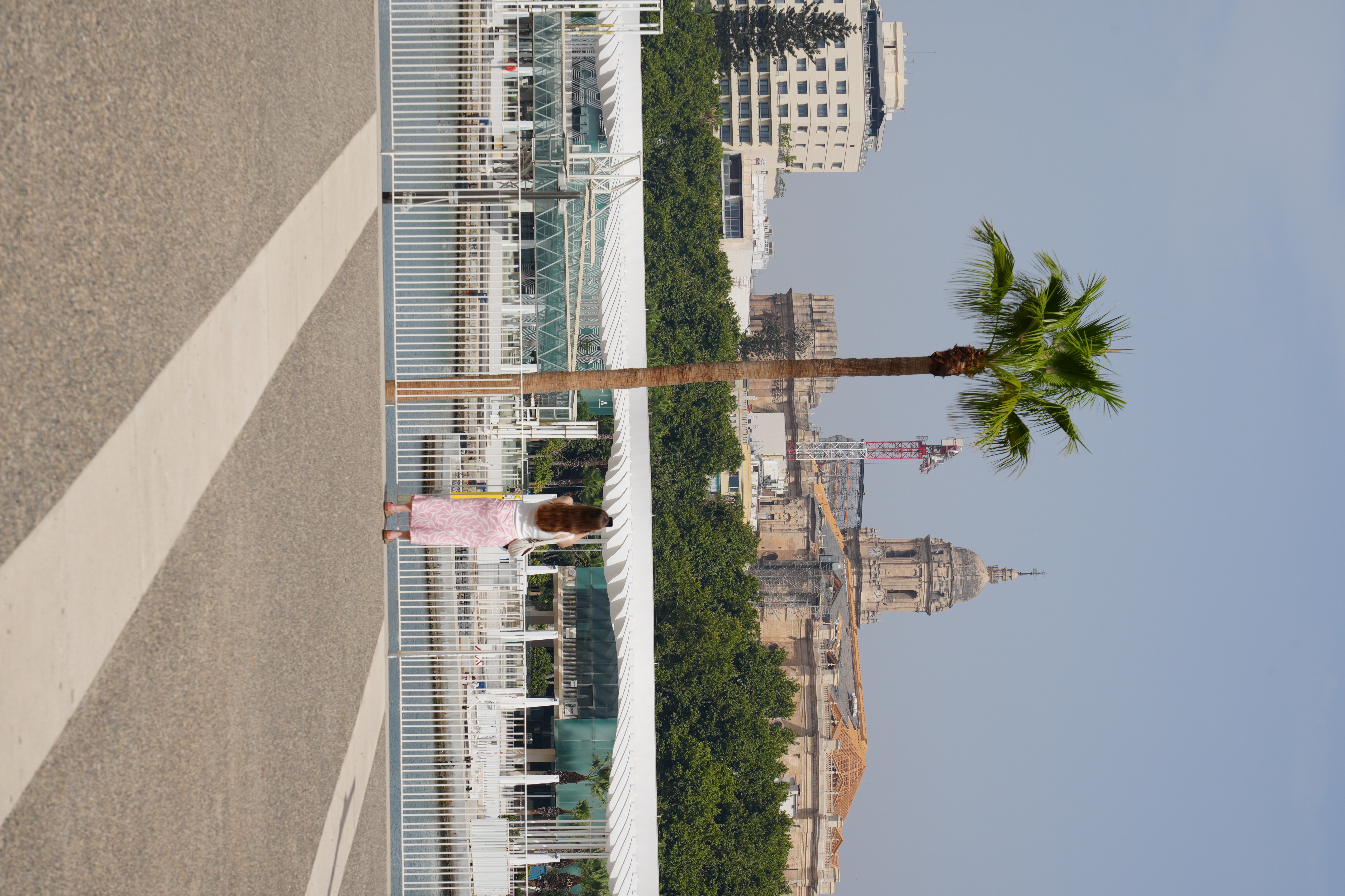 Malaga's port promenade with the cathedral tower visible in the distance