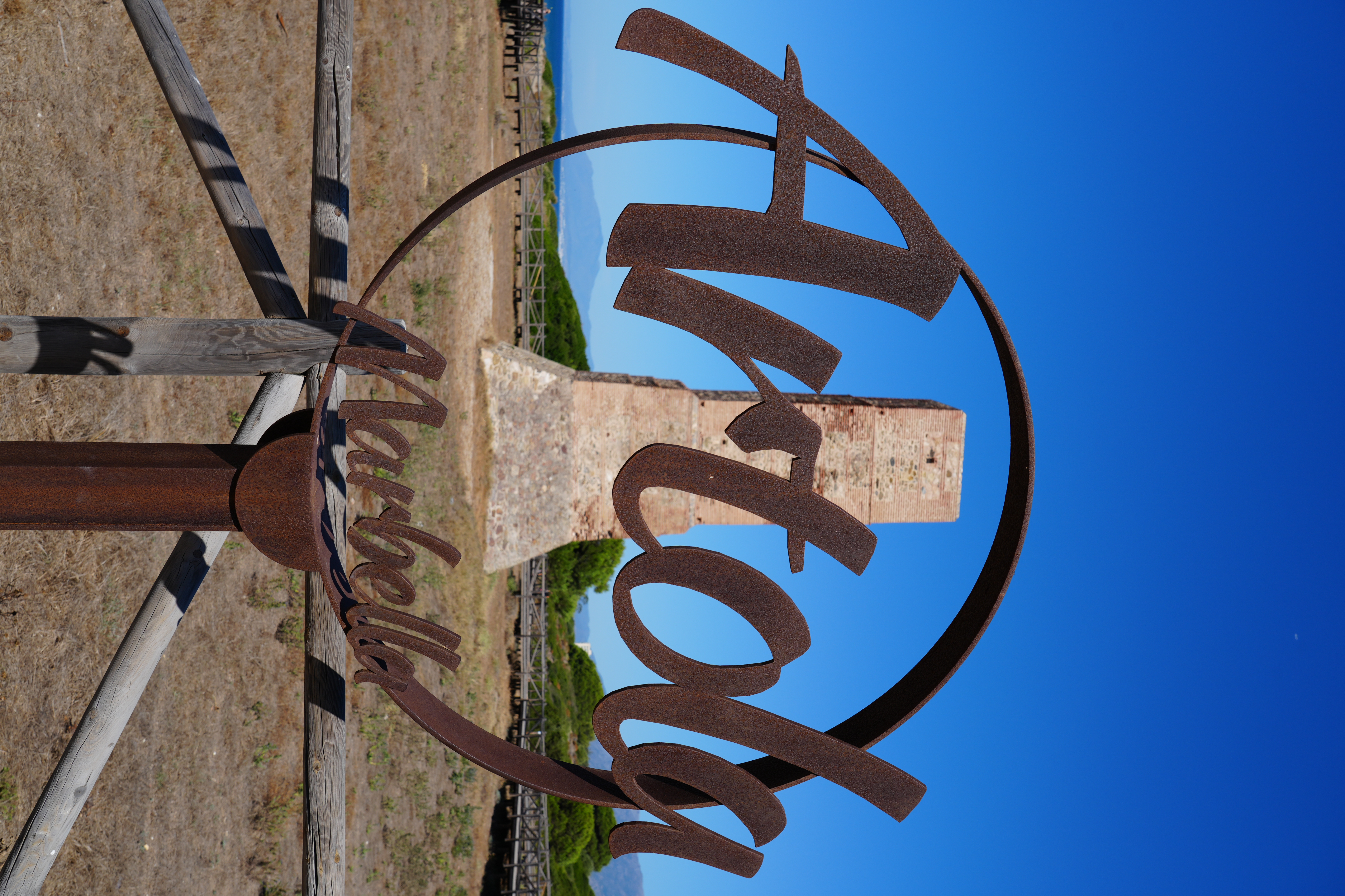 A rusted metal Marbella sign near the Artola watchtower
