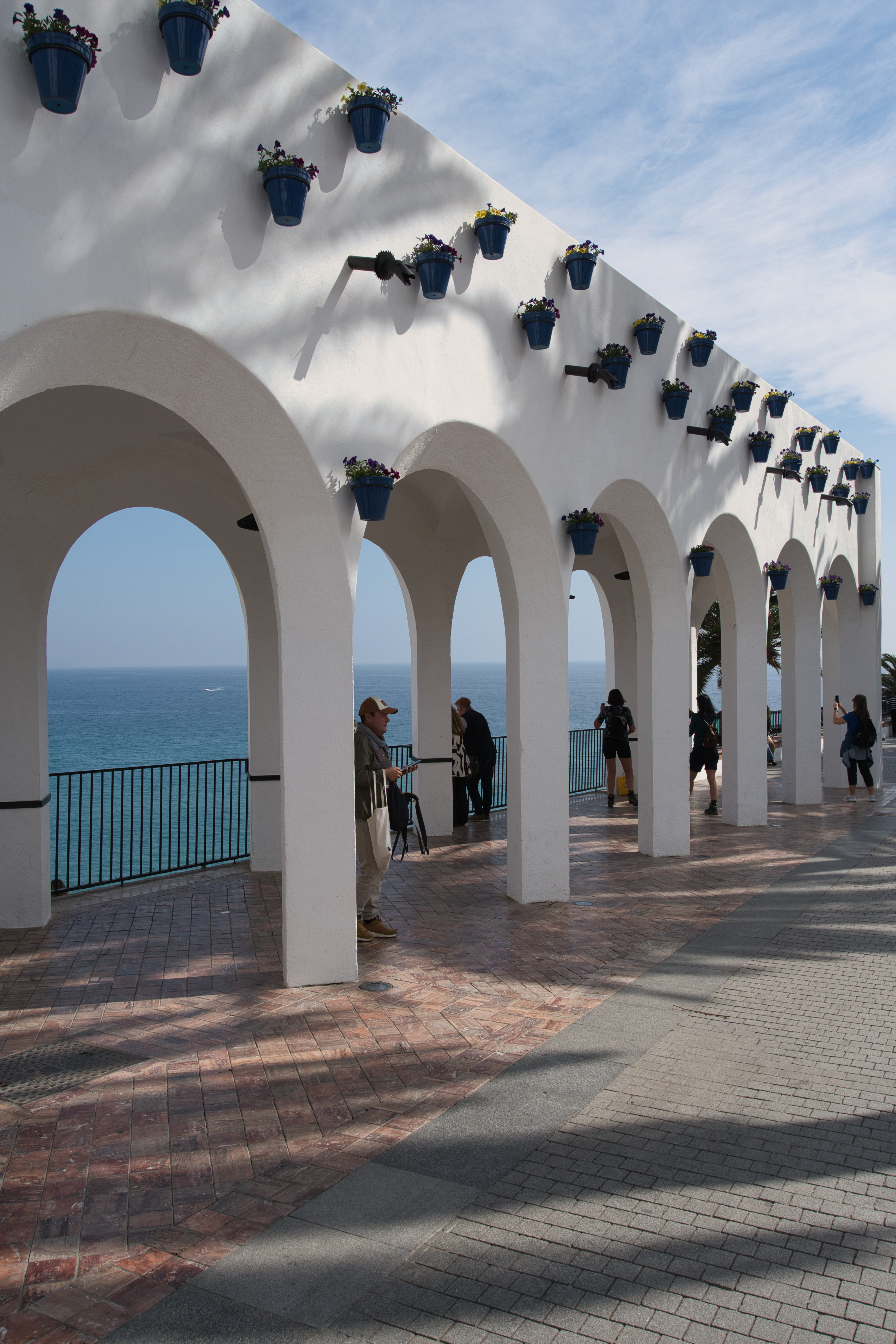 Whitewashed arches at the Balcon de Europa in Nerja, with the sea beyond