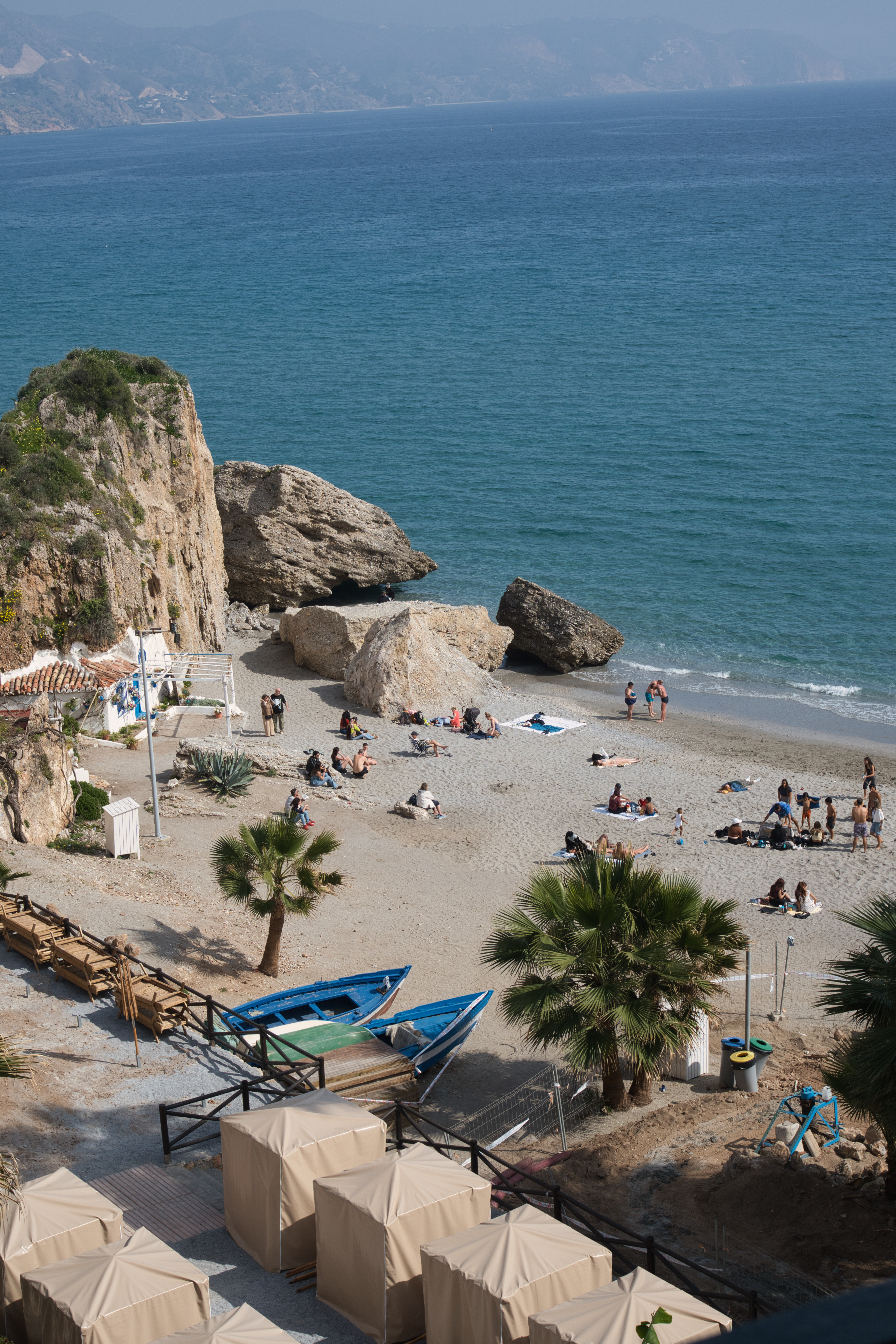 Aerial view of Calahonda beach in Nerja, framed by cliffs and rocks