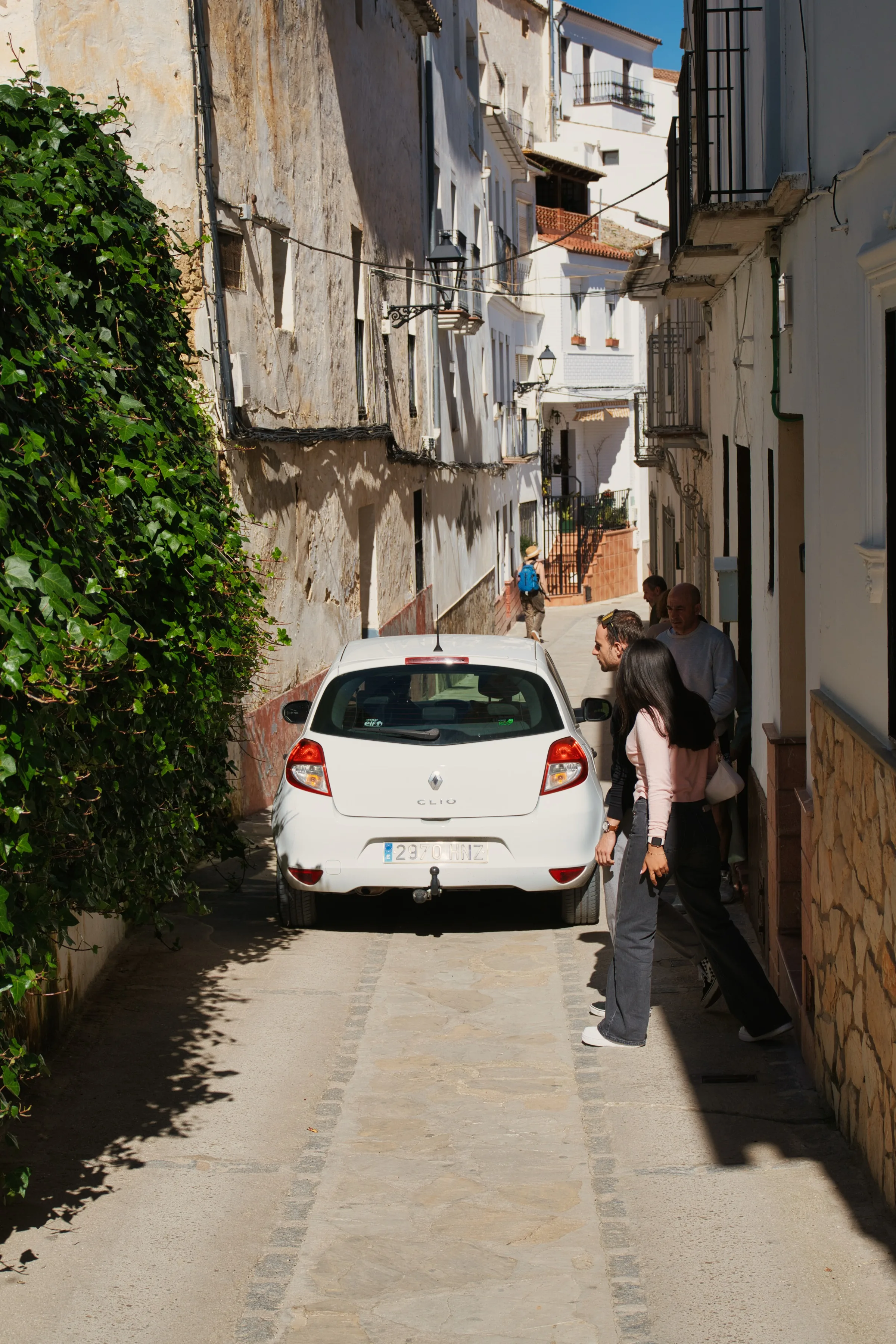 Car squeezed through a narrow street in Setenil de las Bodegas