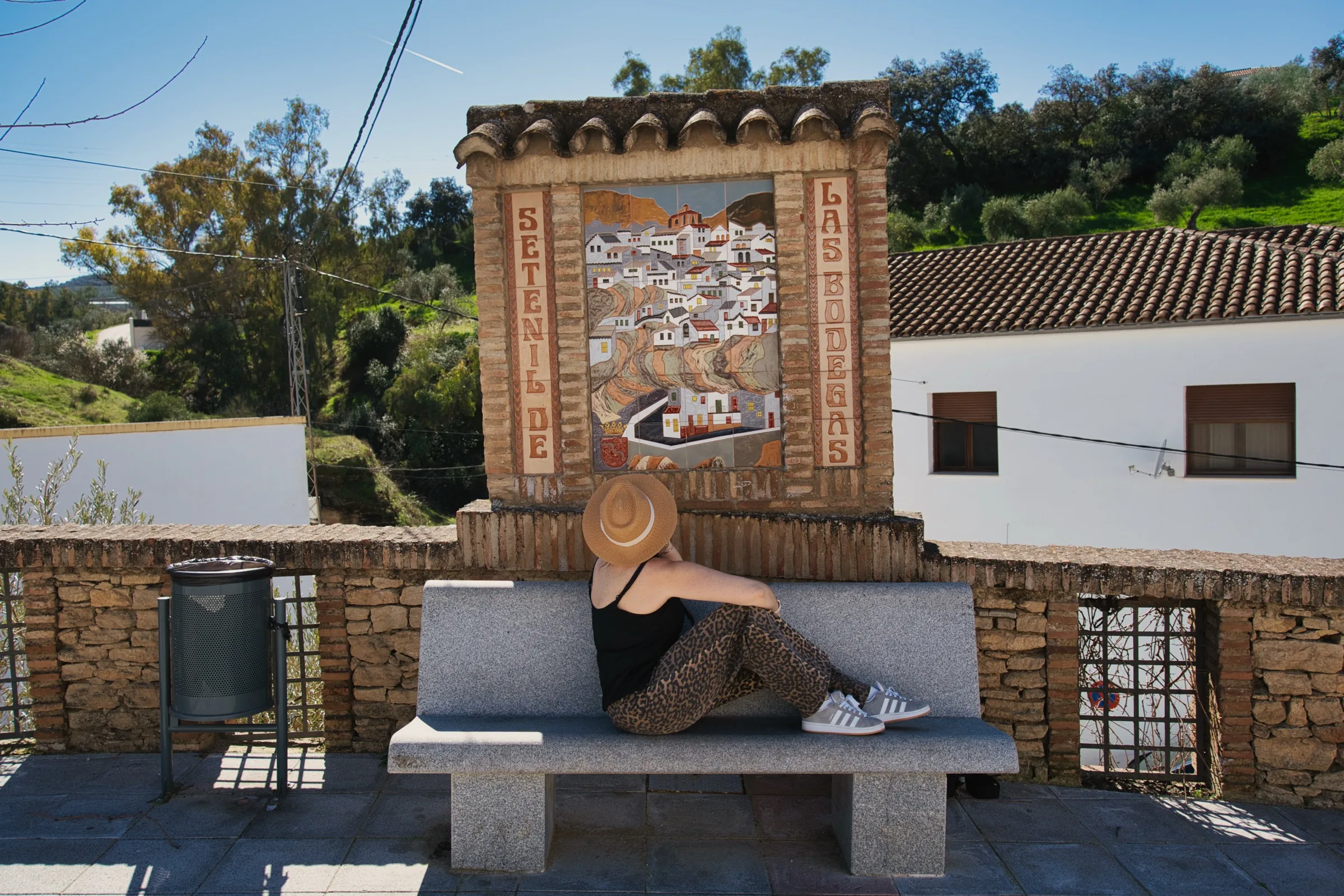 Welcome sign and bench at the entrance to Setenil de las Bodegas village