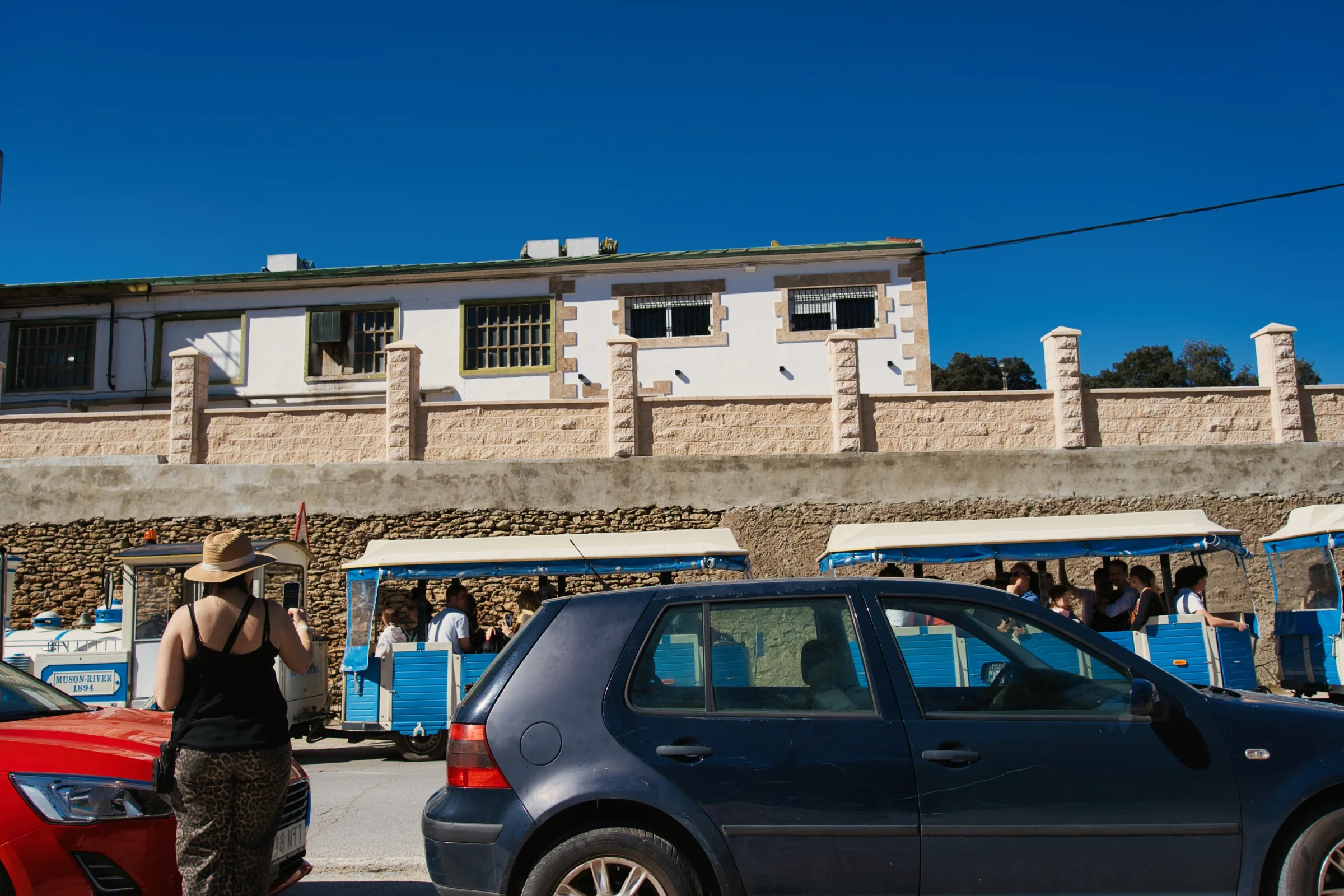 Blue shuttle train carrying visitors from the car park to Setenil de las Bodegas