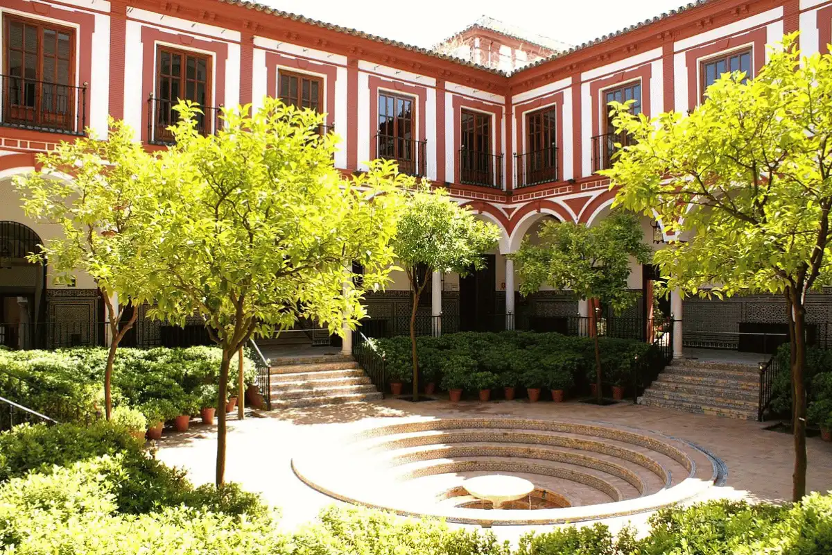 Arched courtyard with fountain inside Casa de Pilatos palace in Seville