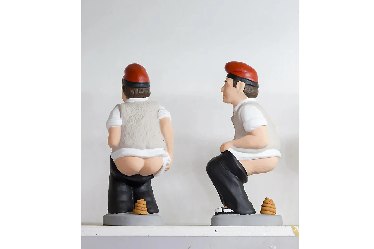 A figure of a man with a red hat relieving himself, traditionally called caga tio, or caganer.