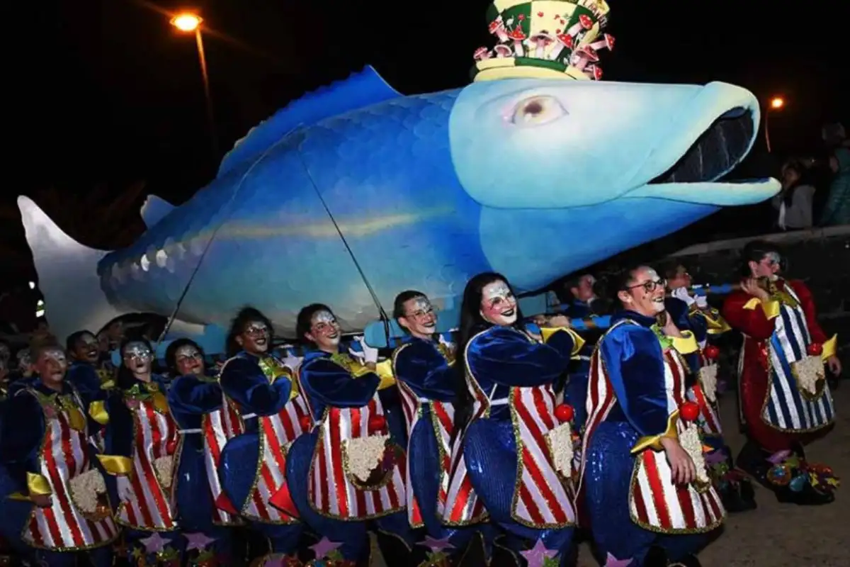 Sardine effigy being carried in procession at El Entierro de la Sardina carnival finale