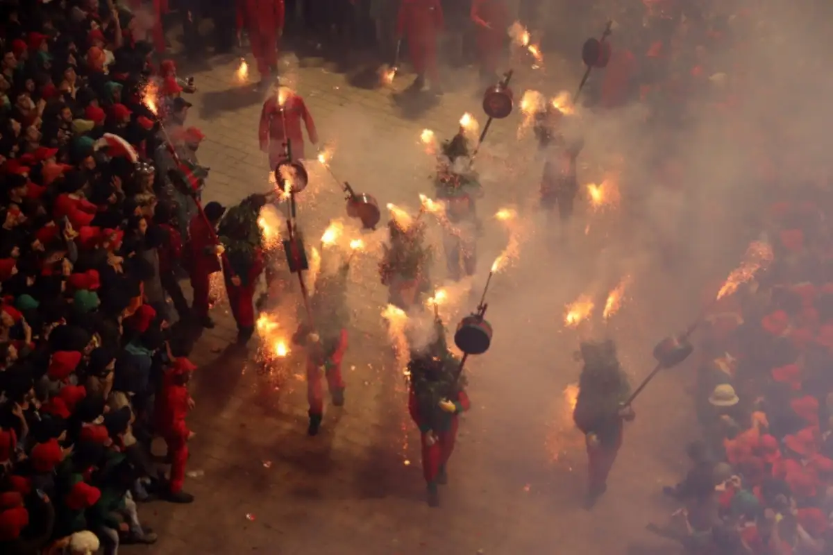 Fire-breathing giant figures parading through Berga during La Patum festival in Catalonia