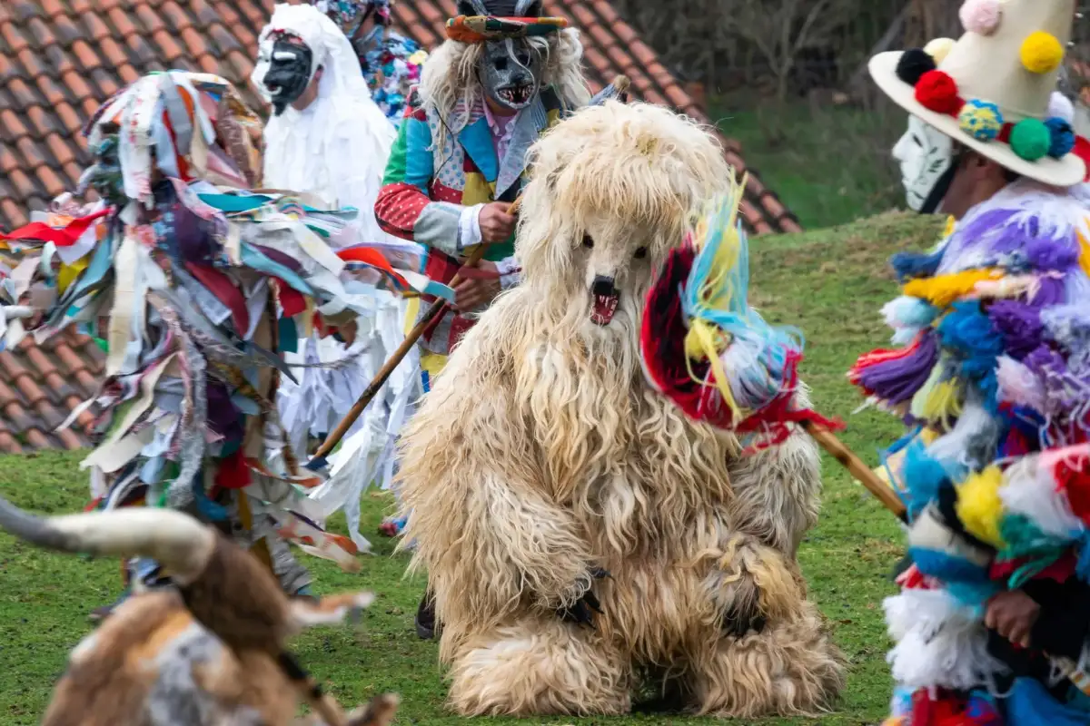 Costumed figures in animal masks parading through Silio during La Vijanera in Cantabria