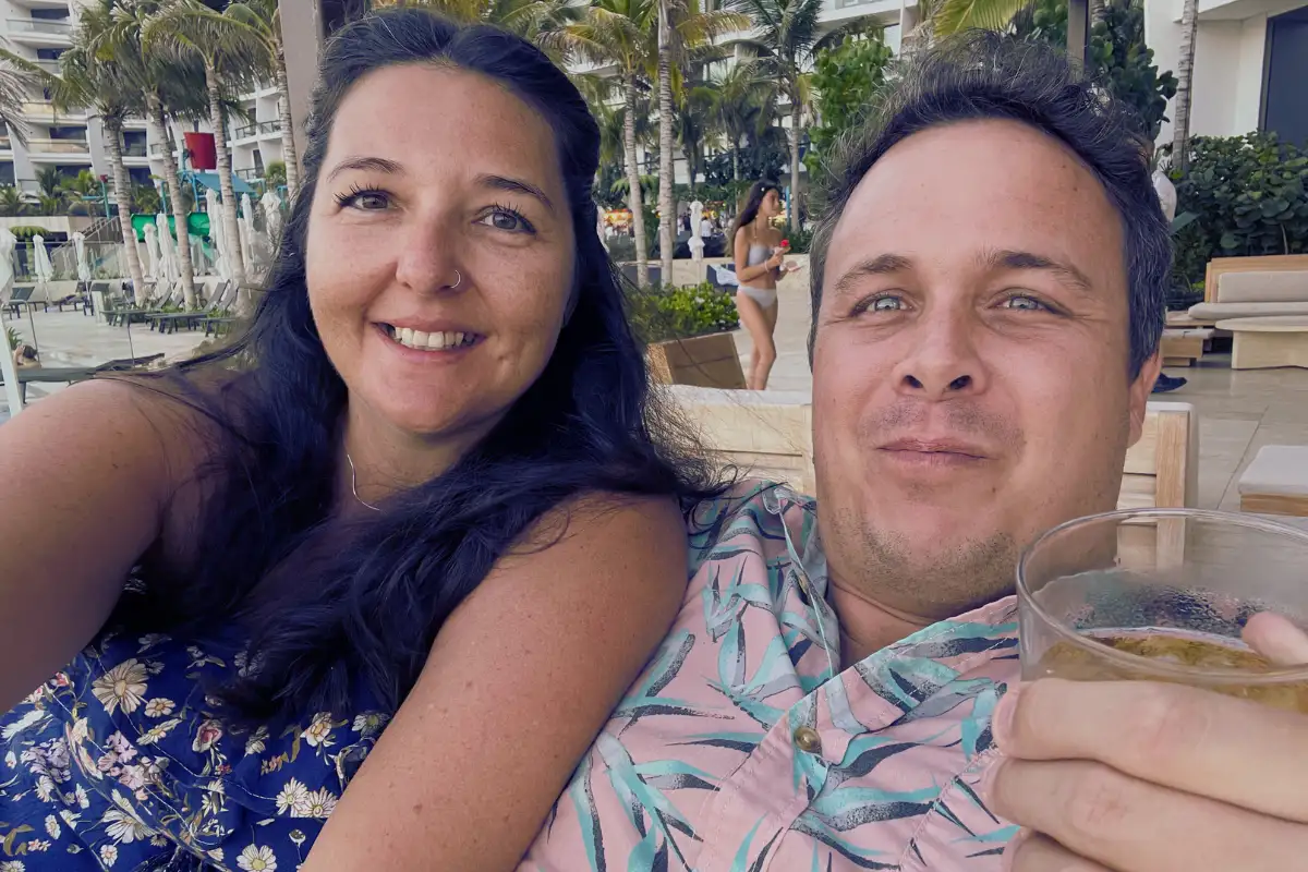 Heidi and Jethro with drinks at a sunny resort in Spain