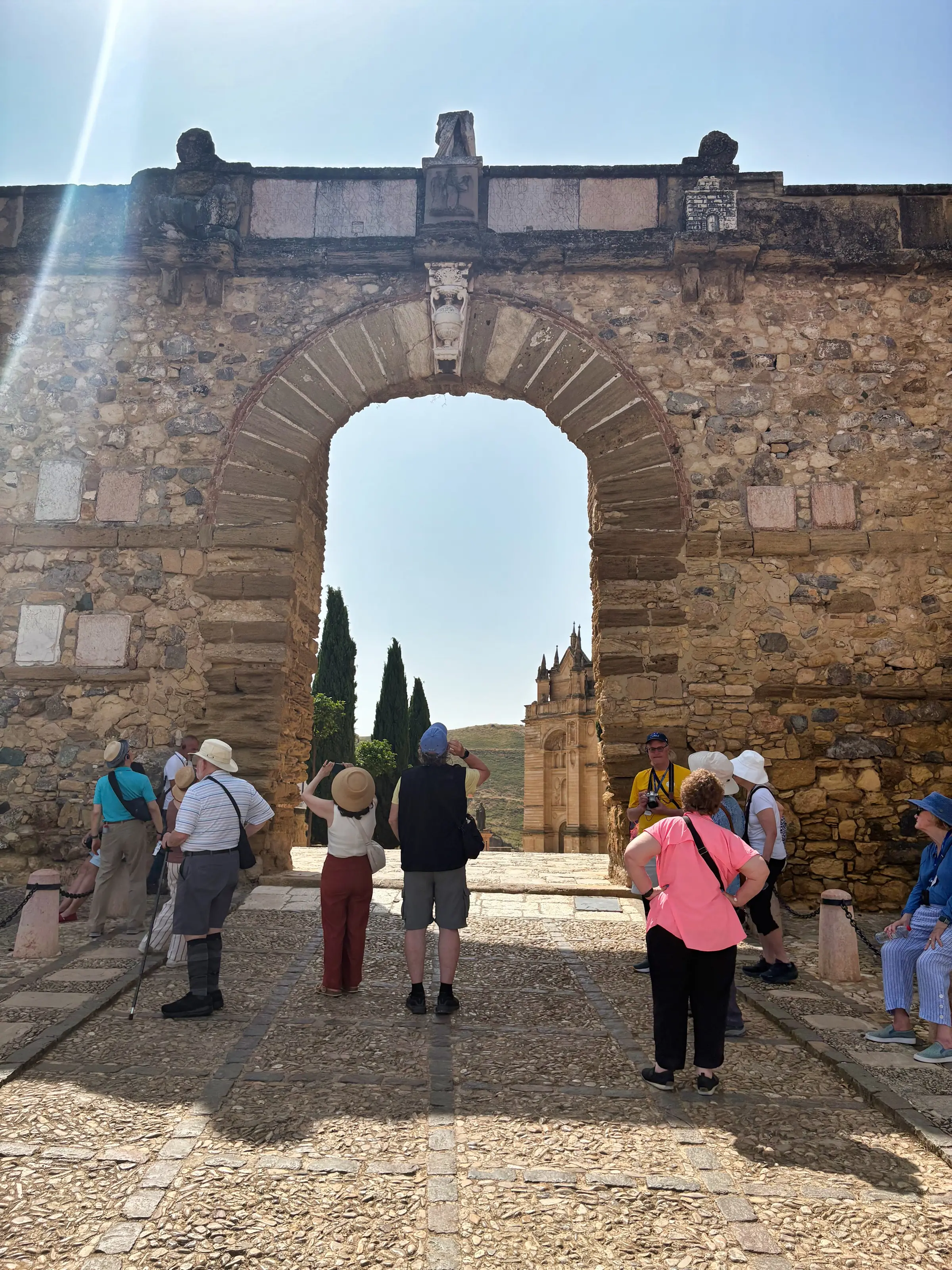 Antequera cathedral seen through a stone arch