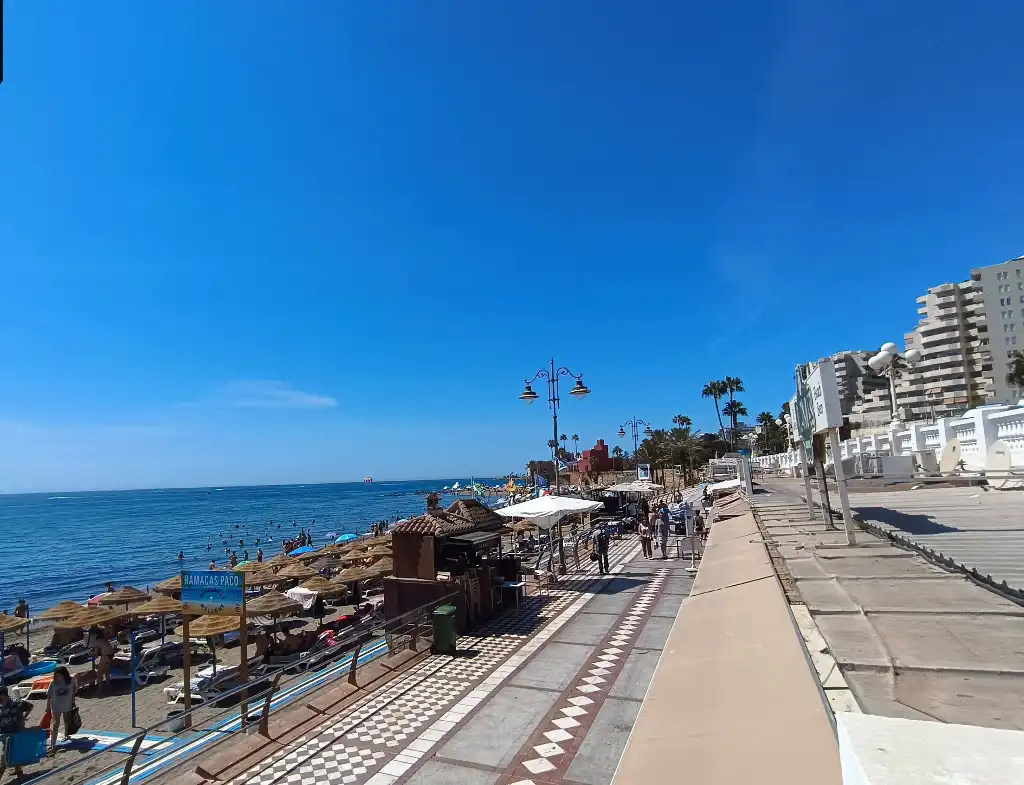 Playa de Santa Ana promenade with sunbeds, chiringuitos and the sea in Benalmadena