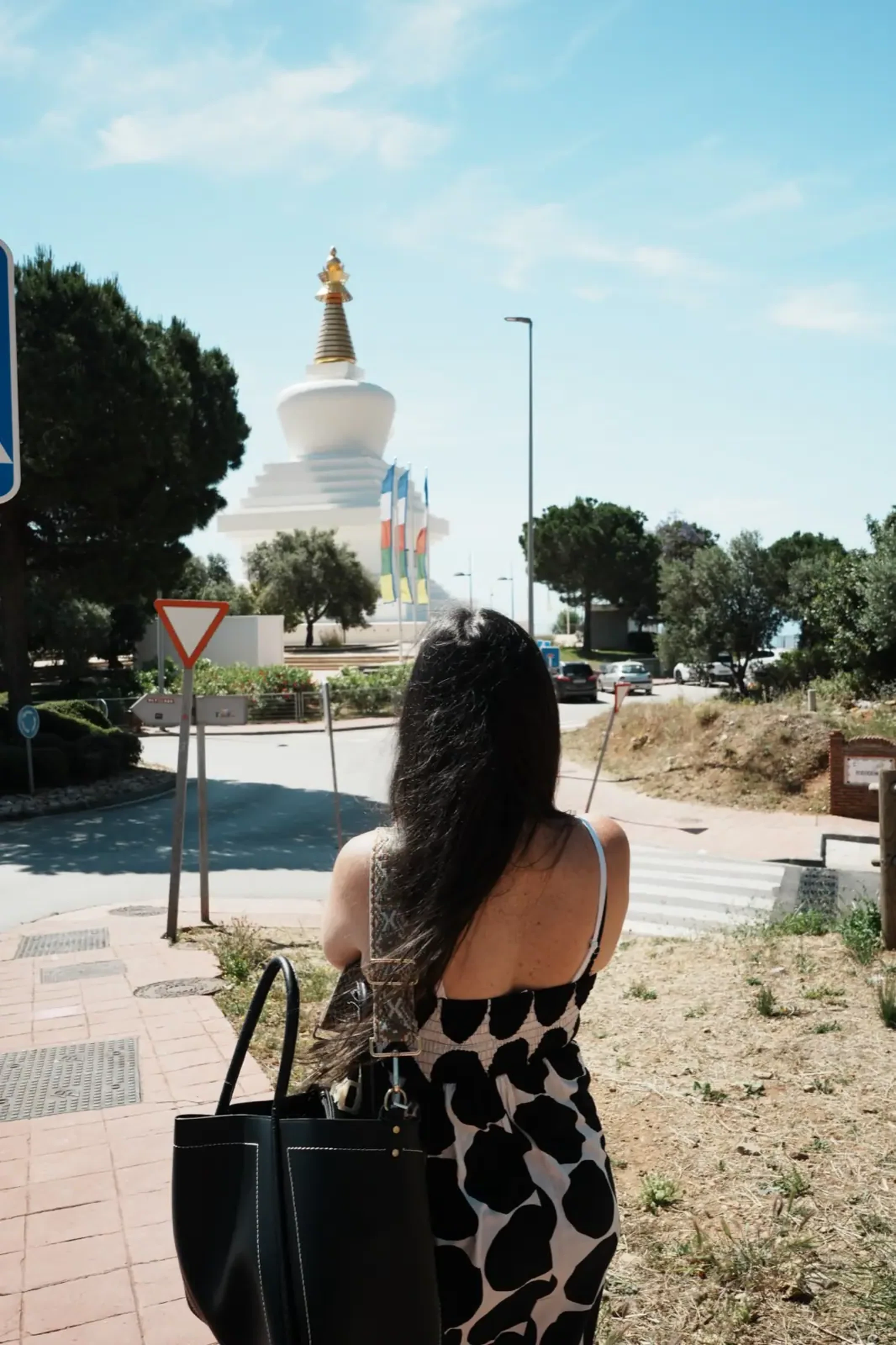 Heidi looking up at the Stupa of Enlightenment in Benalmadena