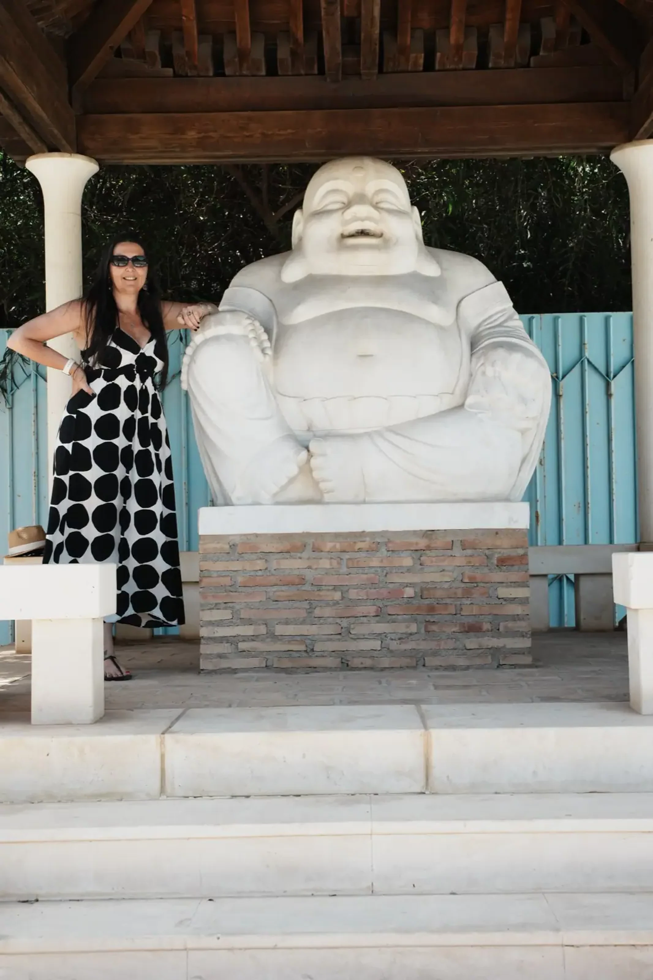 Heidi posing next to the large white Happy Buddha statue in Benalmadena