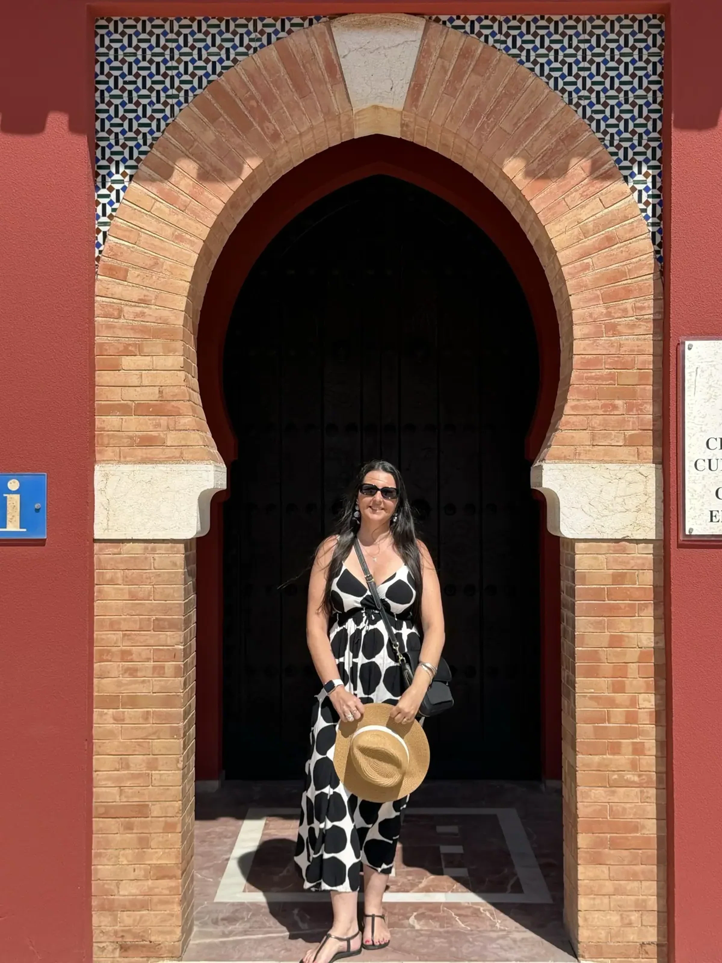 Heidi standing in the Moorish arch entrance of Castillo de Bil-Bil on the Benalmadena seafront