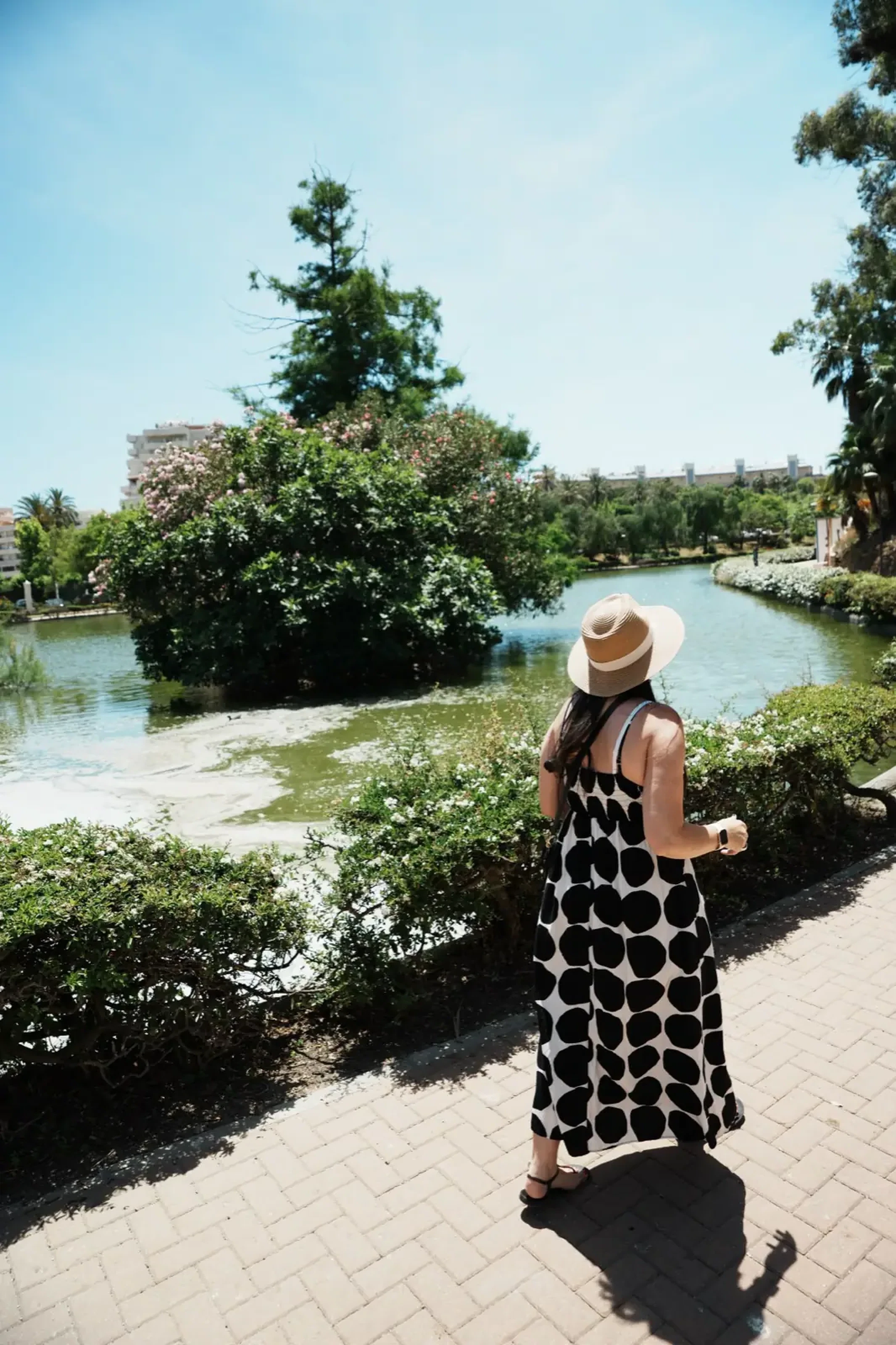 Heidi walking through Parque de la Paloma in Benalmadena, surrounded by lush greenery