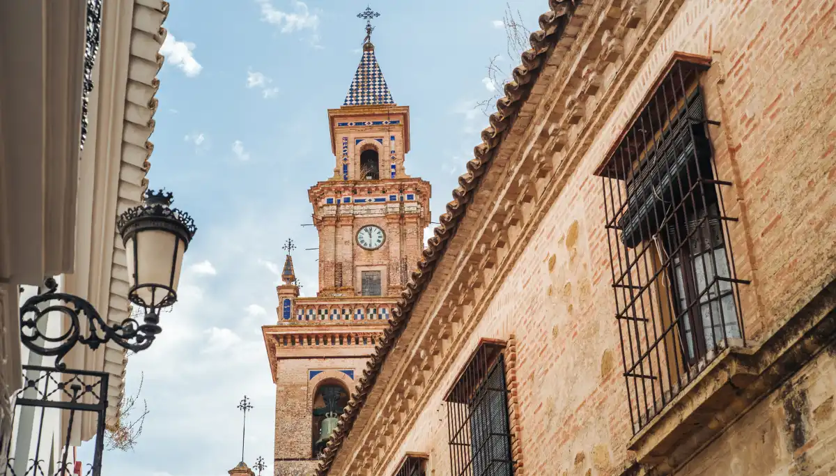 Church bell tower rising above the old town streets of Carmona