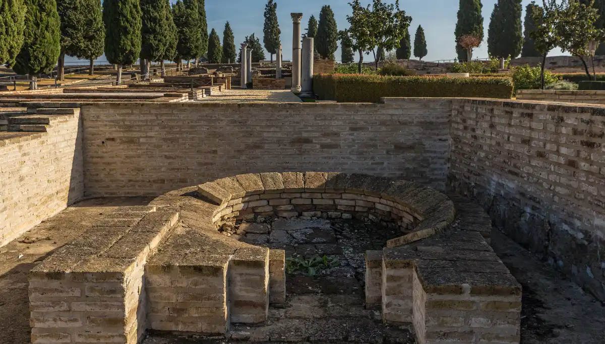 Roman ruins with stone columns and foundations at Italica near Seville