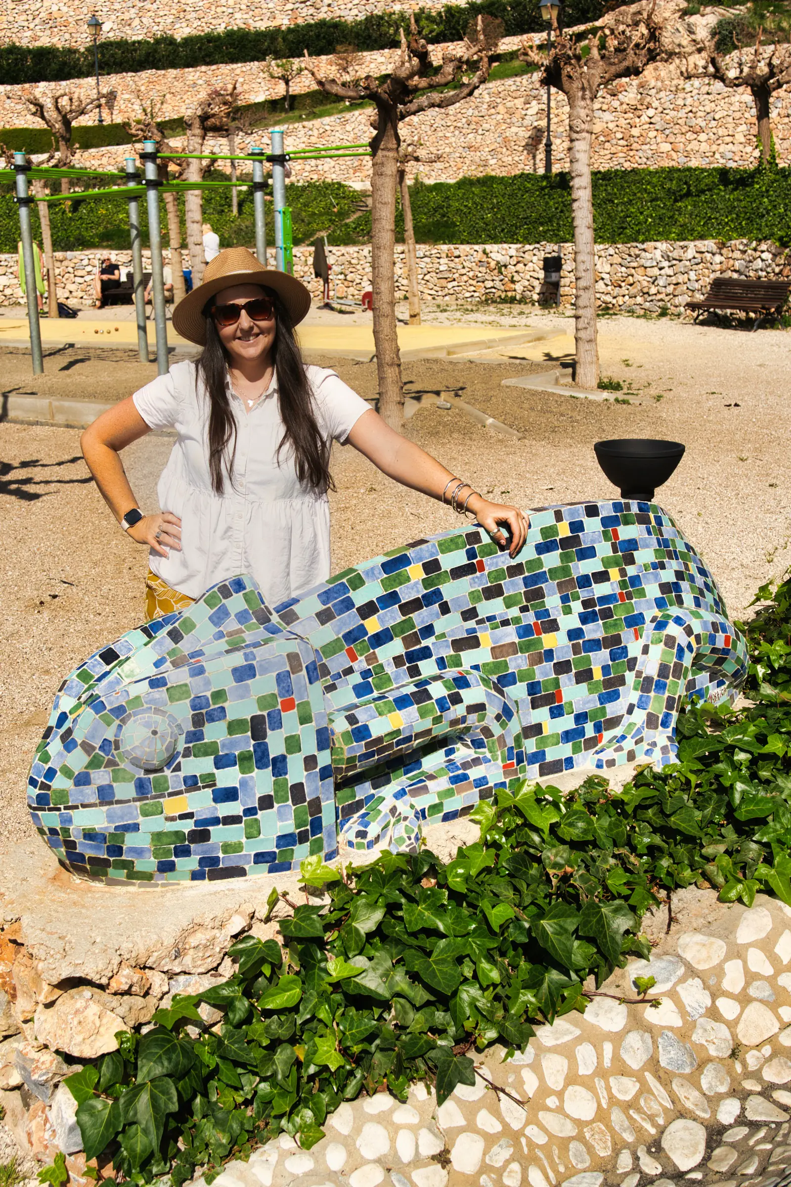 Chameleon and woman in frigiliana botanical gardens.