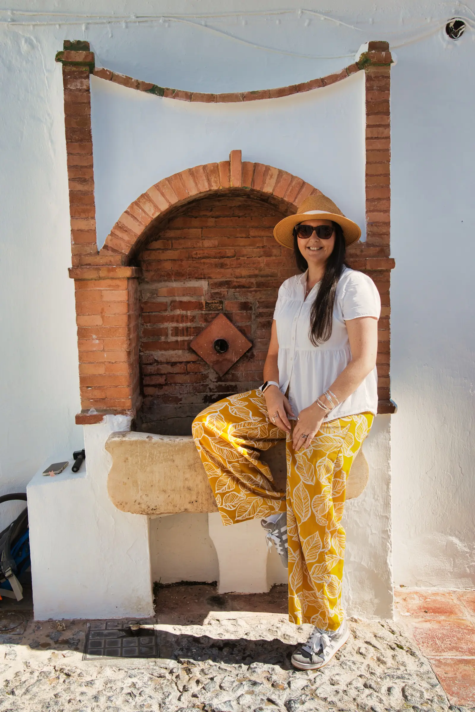 Woman next to fountain.