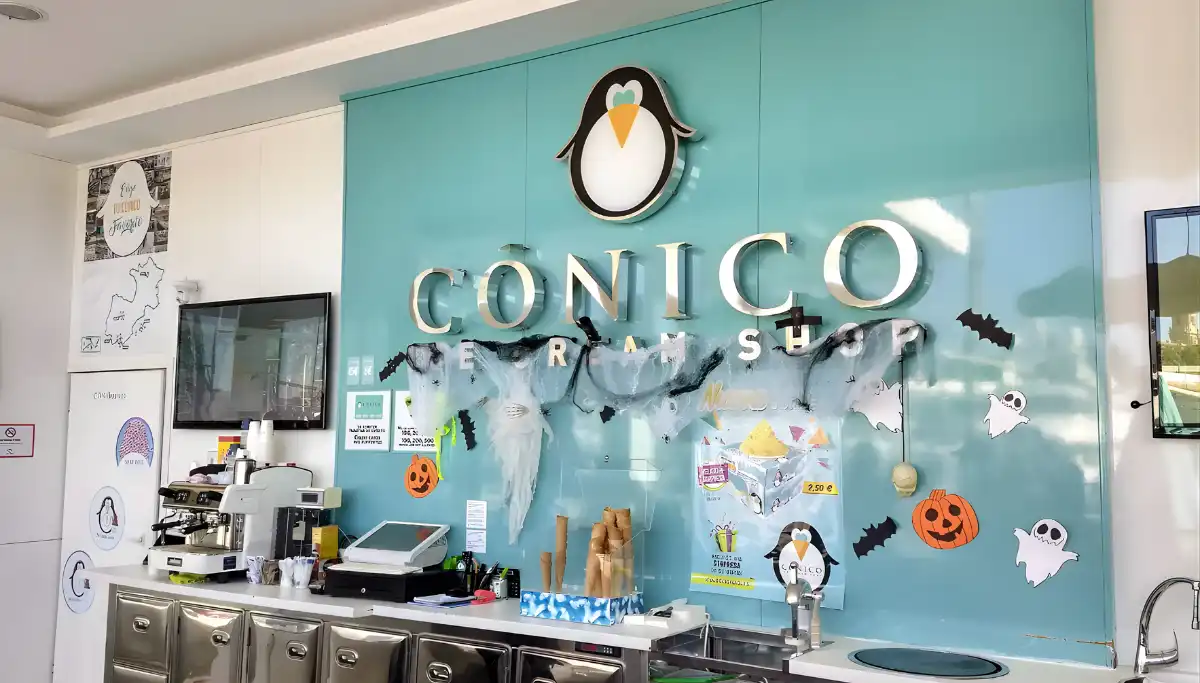 Inside Conico ice cream shop at Muelle Uno in Malaga with penguin logo
