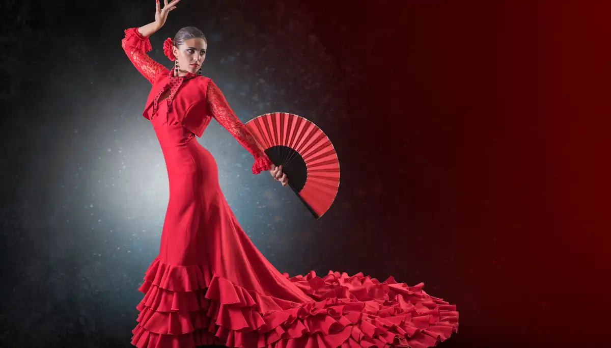 Flamenco dancer in a red dress holding a fan mid-performance