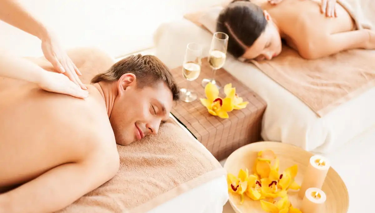 Couple enjoying a relaxing spa massage with champagne