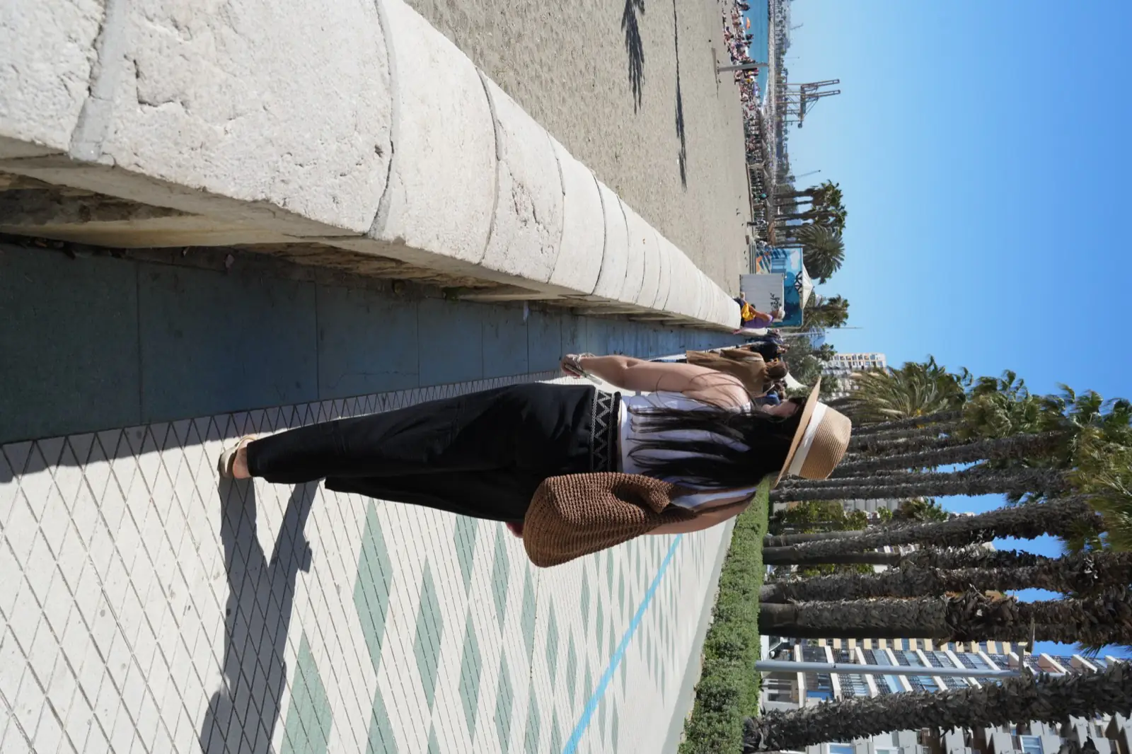 Walking along Malagueta promenade on a sunny day