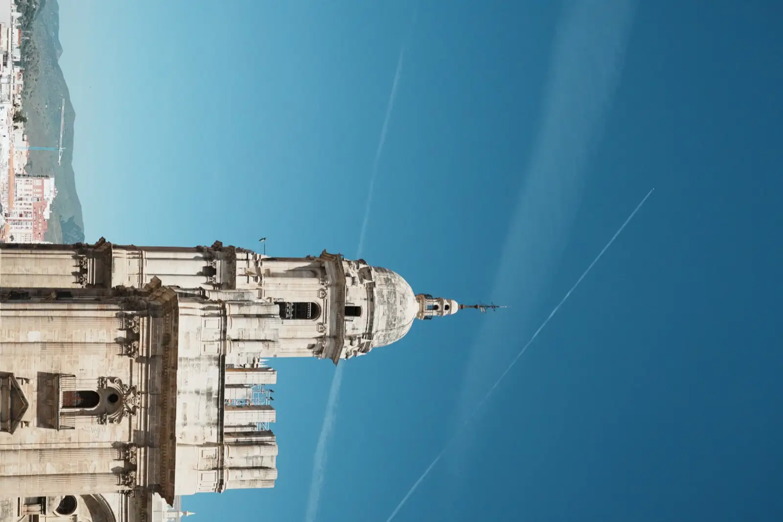 Malaga Cathedral facade against a deep blue sky