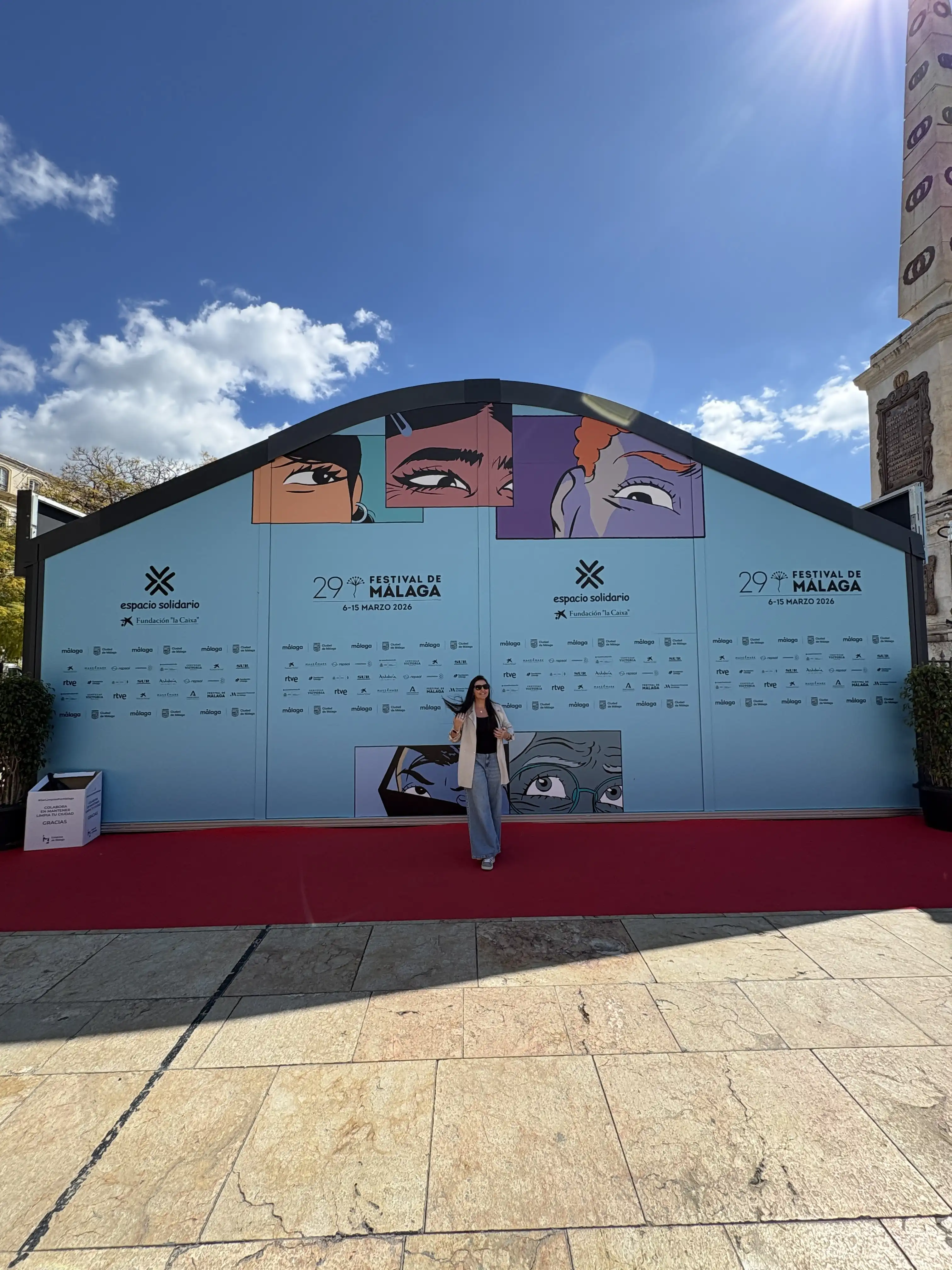 Heidi standing in front of the Festival de Malaga film festival backdrop on the red carpet