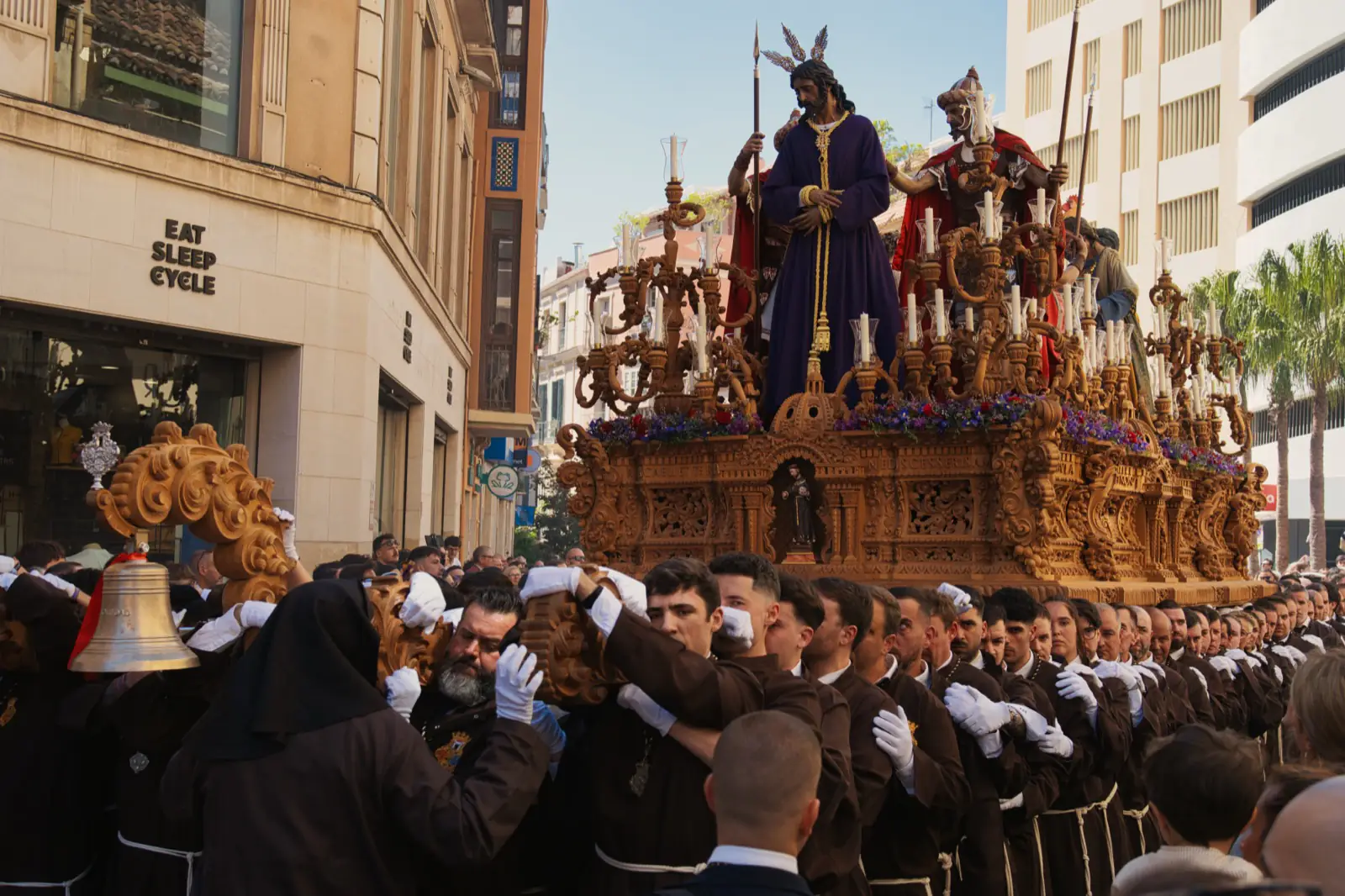 Costaleros carrying a paso through the streets during Semana Santa in Málaga