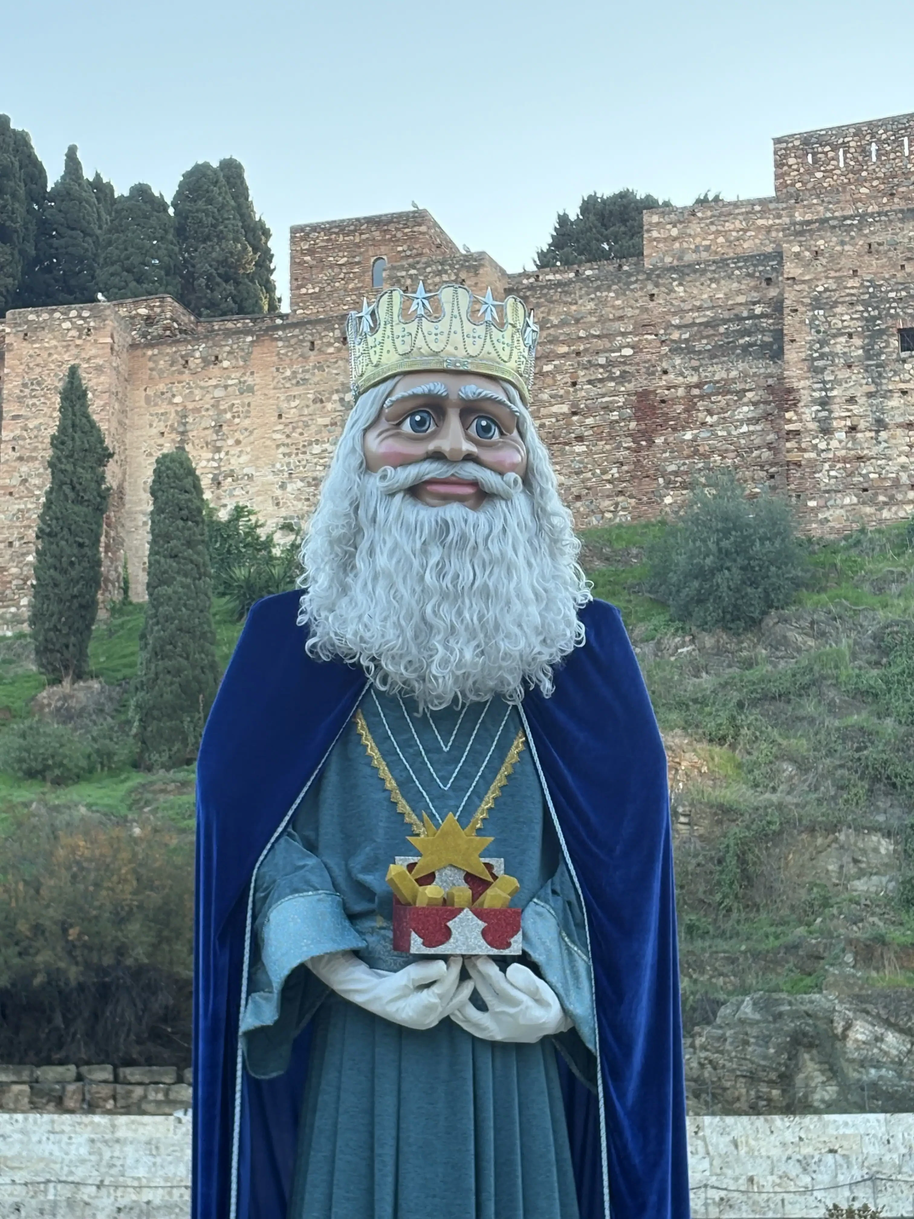 Statue of a king with white beard and blue cloak, part of the Cabalgata de Reyes parade in Malaga