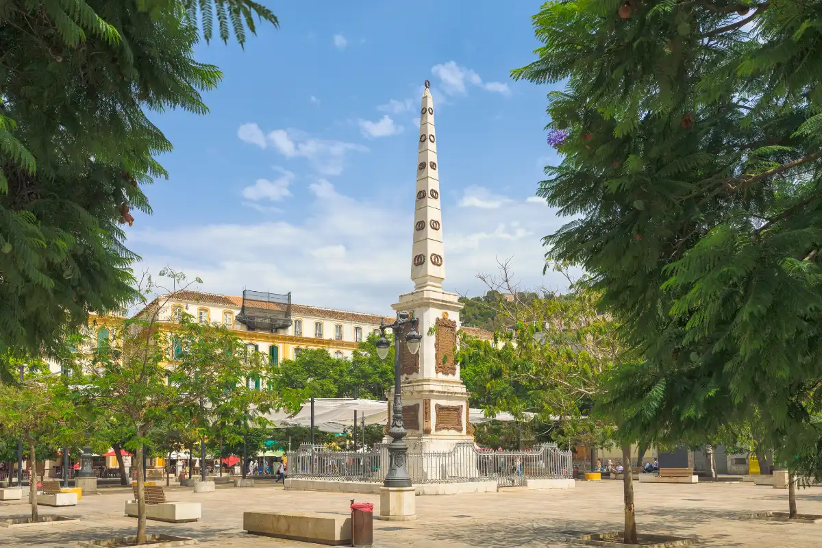 Plaza de la Merced in Málaga with its central obelisk, shaded trees and benches