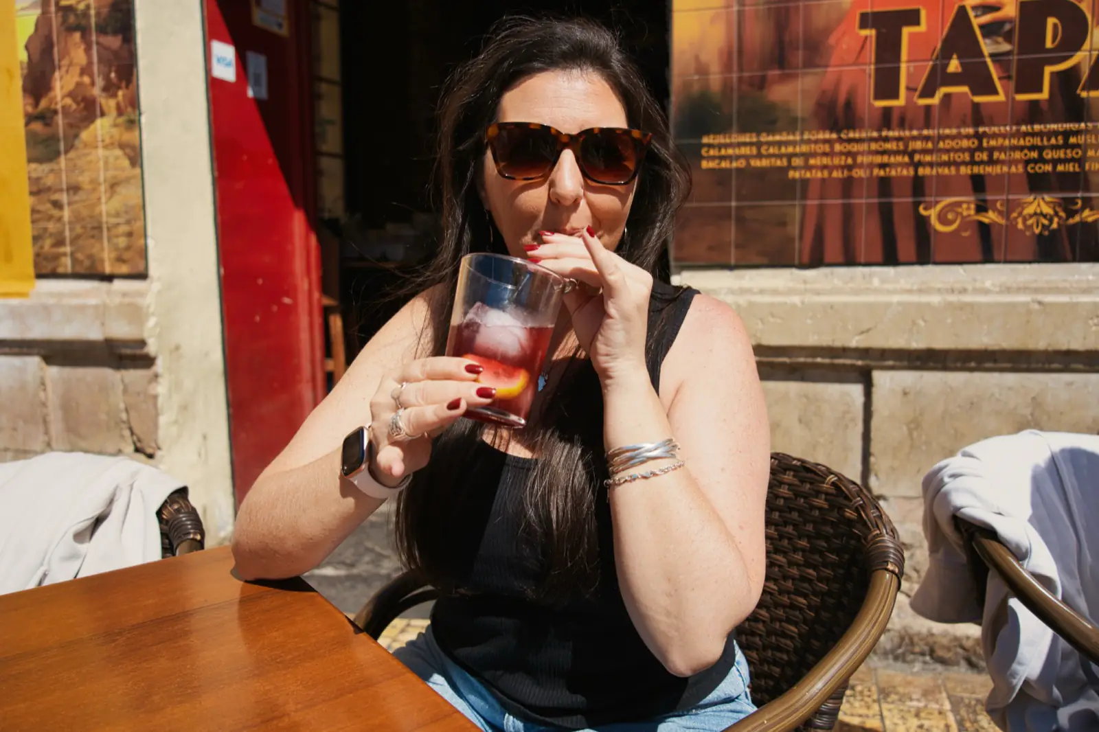 A woman drinking a tinto de verano.